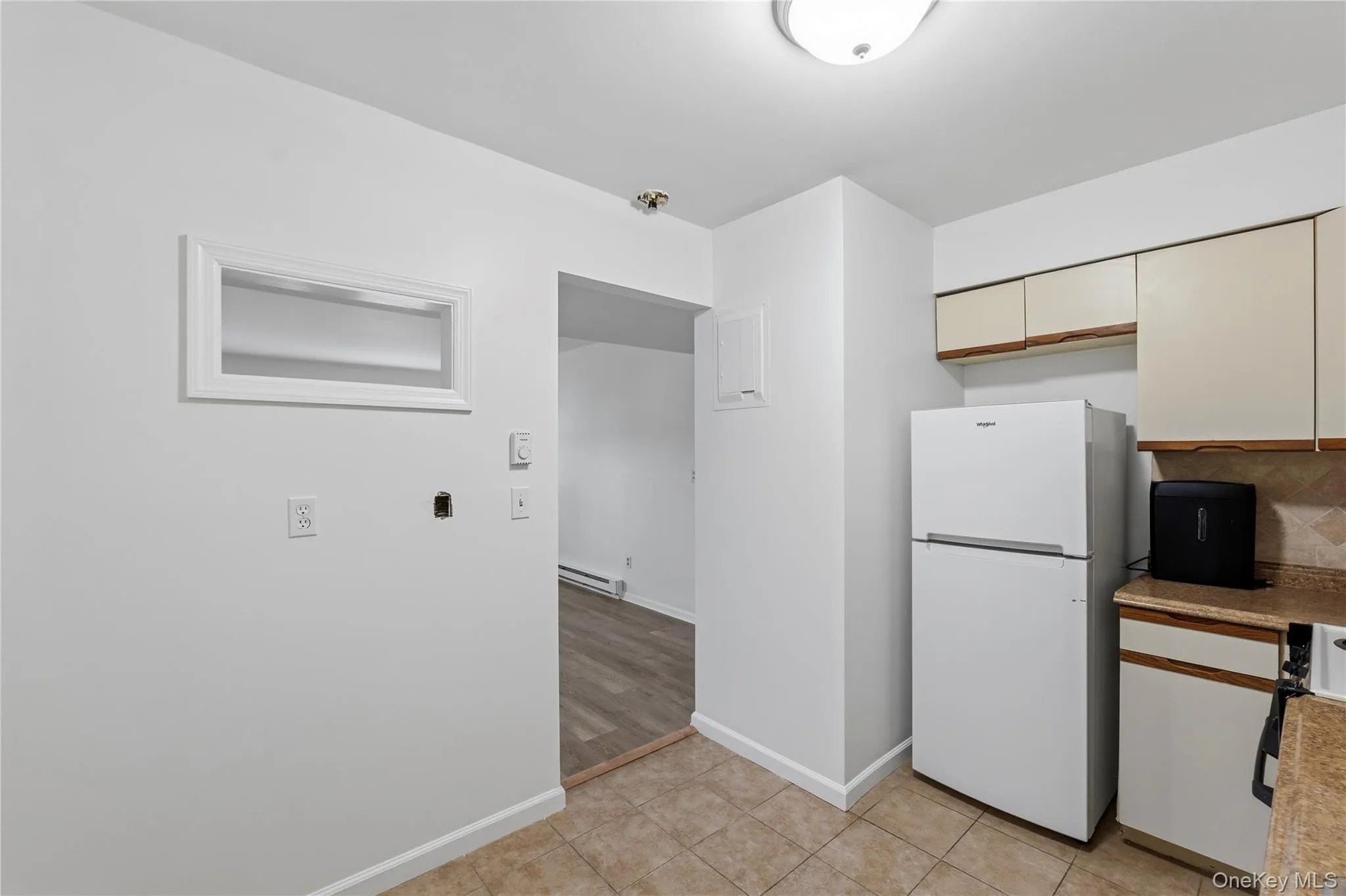 Open space on kitchen wall to living area allows for extra natural light and privacy. Open space on kitchen wall to living area allows for extra natural light and privacy.
