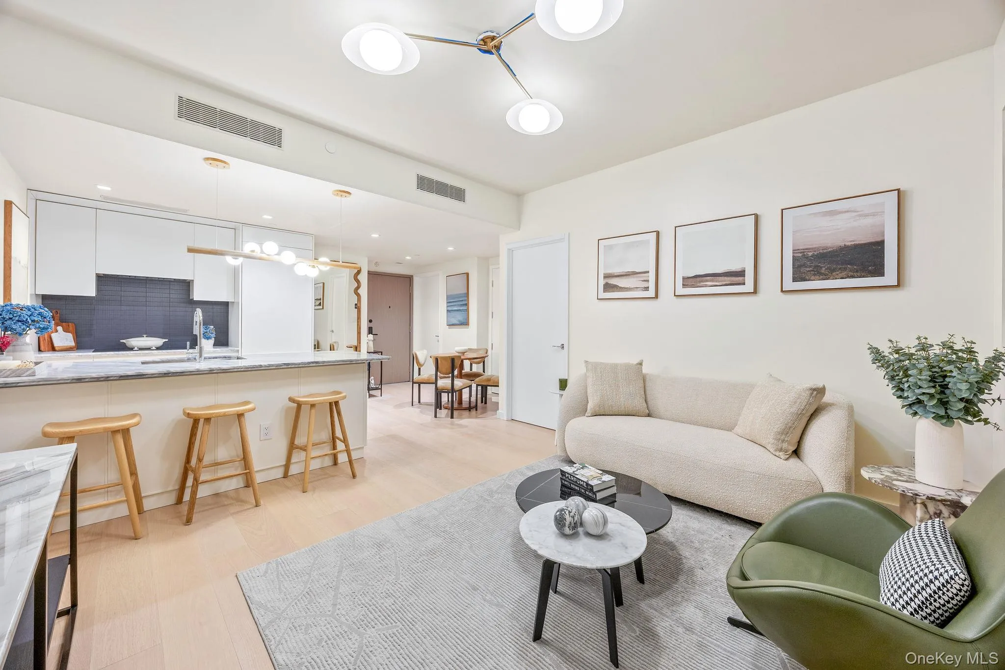 Living area with light wood-style flooring, a chandelier, and recessed lighting Living area with light wood-style flooring, a chandelier, and recessed lighting