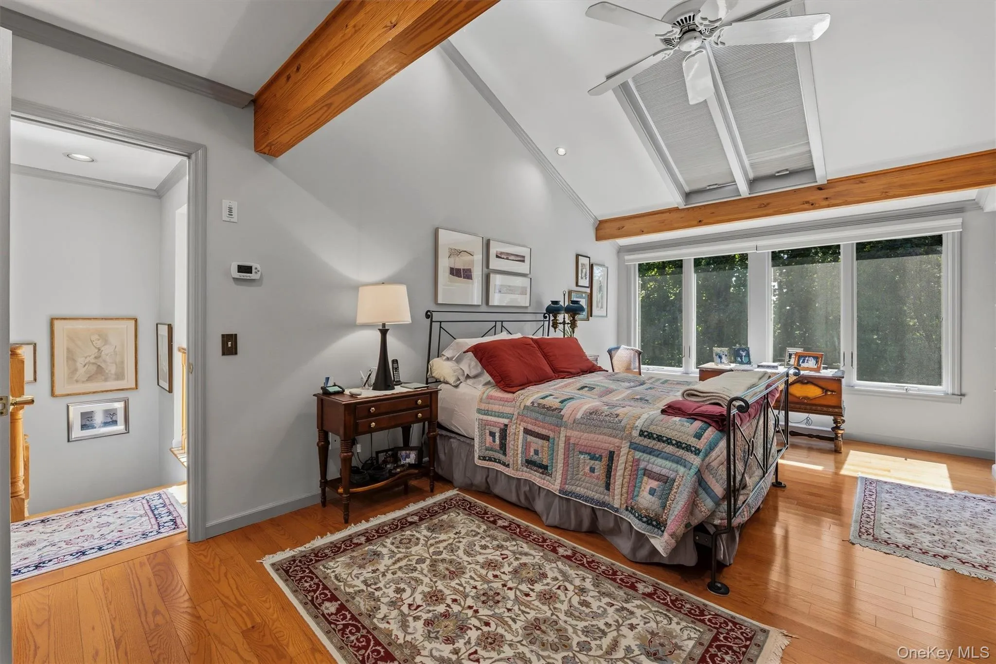 Bedroom with wall of windows and skylights Bedroom with wall of windows and skylights