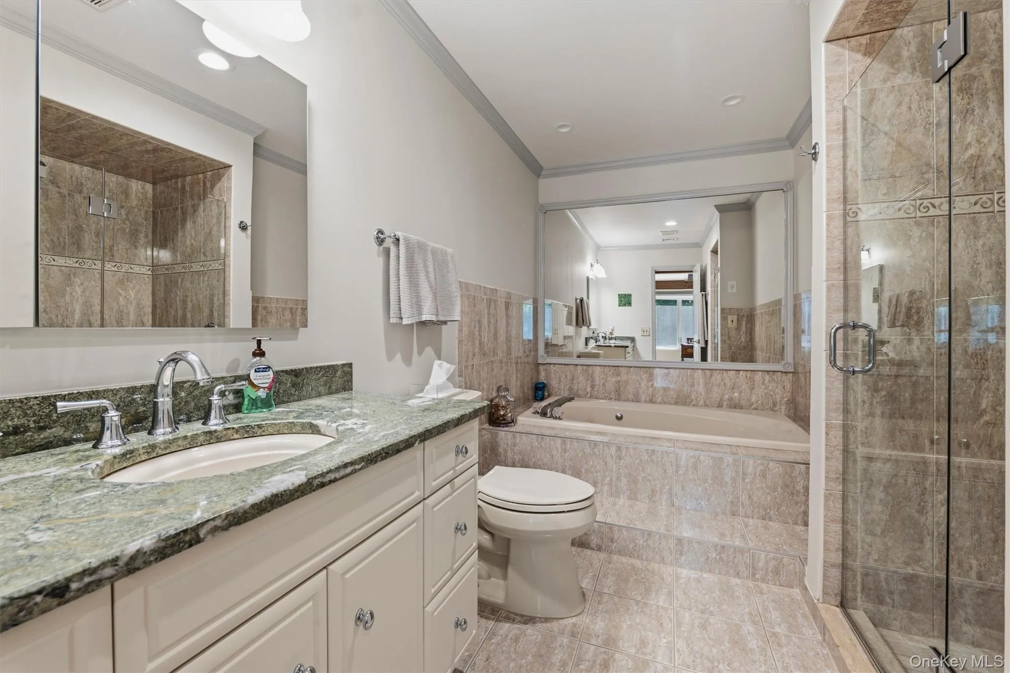 Primary ensuite bathroom with Jacuzzi tub and shower Primary ensuite bathroom with Jacuzzi tub and shower