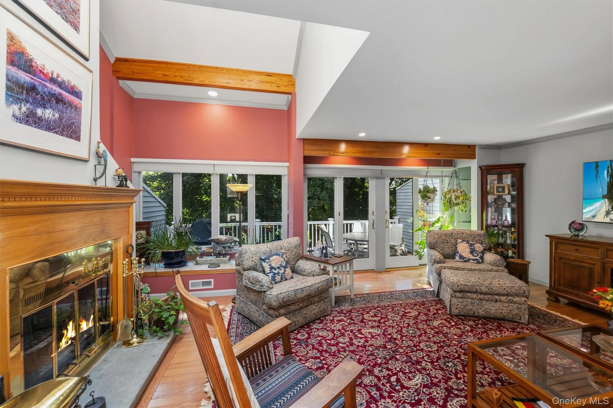 Living room with wall of windows and doors out to deck. Living room with wall of windows and doors out to deck.