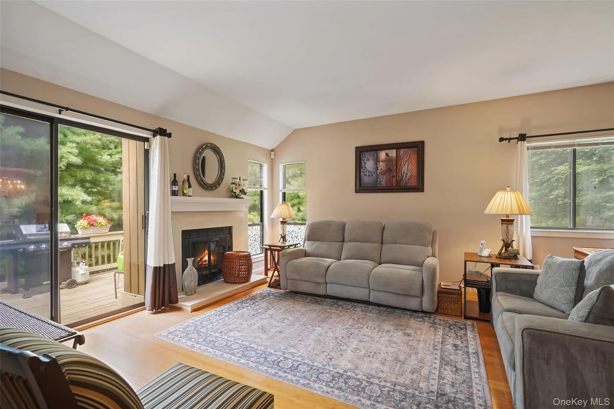Formal living room with wood-burning fireplace and sliders to the backyard deck Formal living room with wood-burning fireplace and sliders to the backyard deck