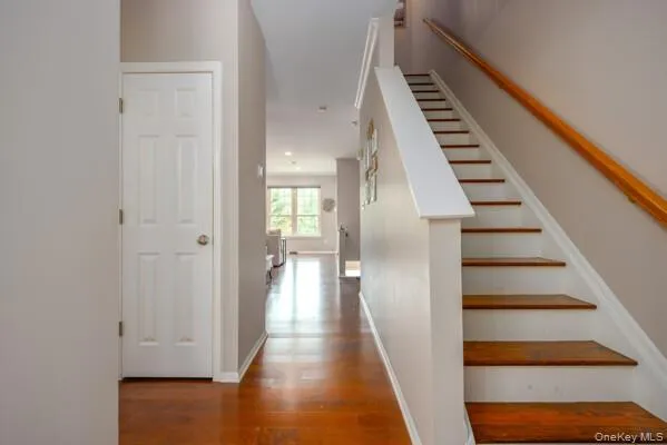 staircase with wood treads and a wood handrail leads to the second level. staircase with wood treads and a wood handrail leads to the second level.