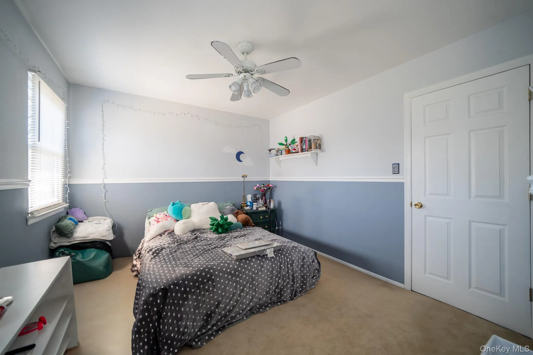 Carpeted bedroom featuring a ceiling fan Carpeted bedroom featuring a ceiling fan