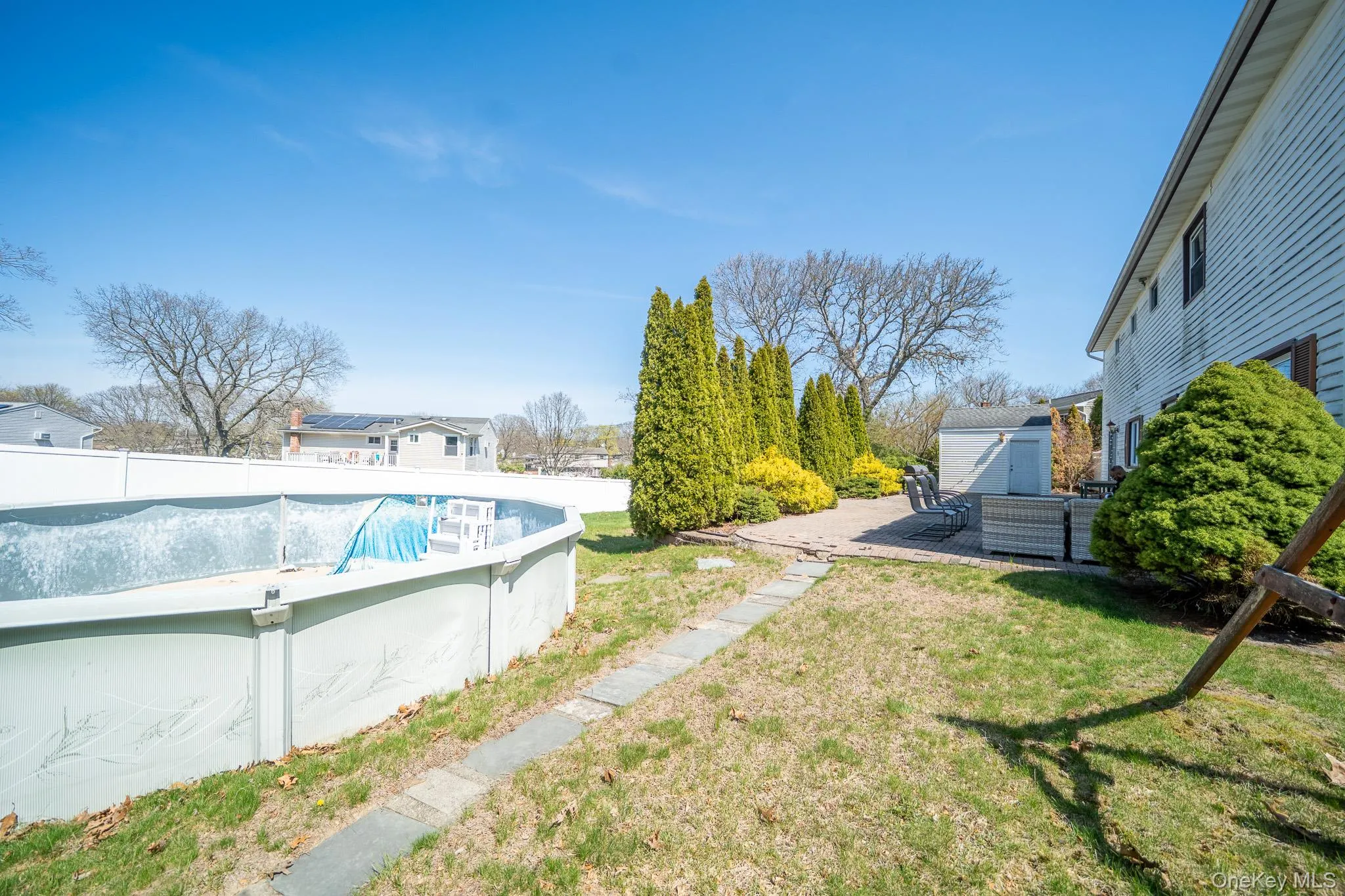 View of pool featuring a patio area, an outdoor structure, fence, a yard, and a fenced in pool View of pool featuring a patio area, an outdoor structure, fence, a yard, and a fenced in pool