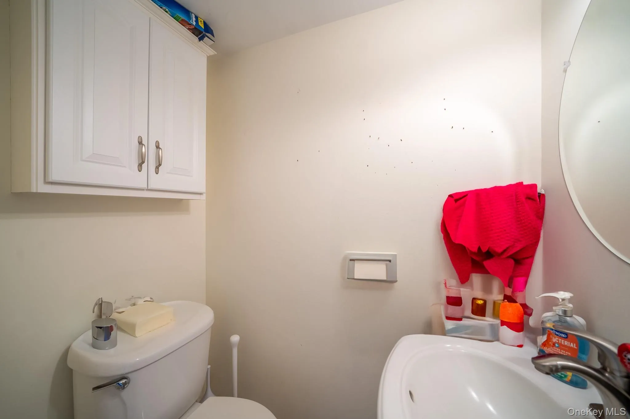Bathroom featuring toilet and a sink Bathroom featuring toilet and a sink