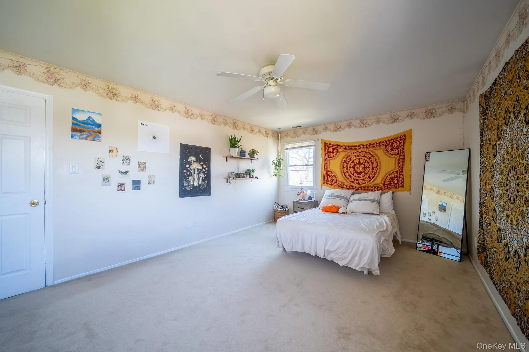 Bedroom featuring wallpapered walls, carpet, a ceiling fan, and baseboards Bedroom featuring wallpapered walls, carpet, a ceiling fan, and baseboards