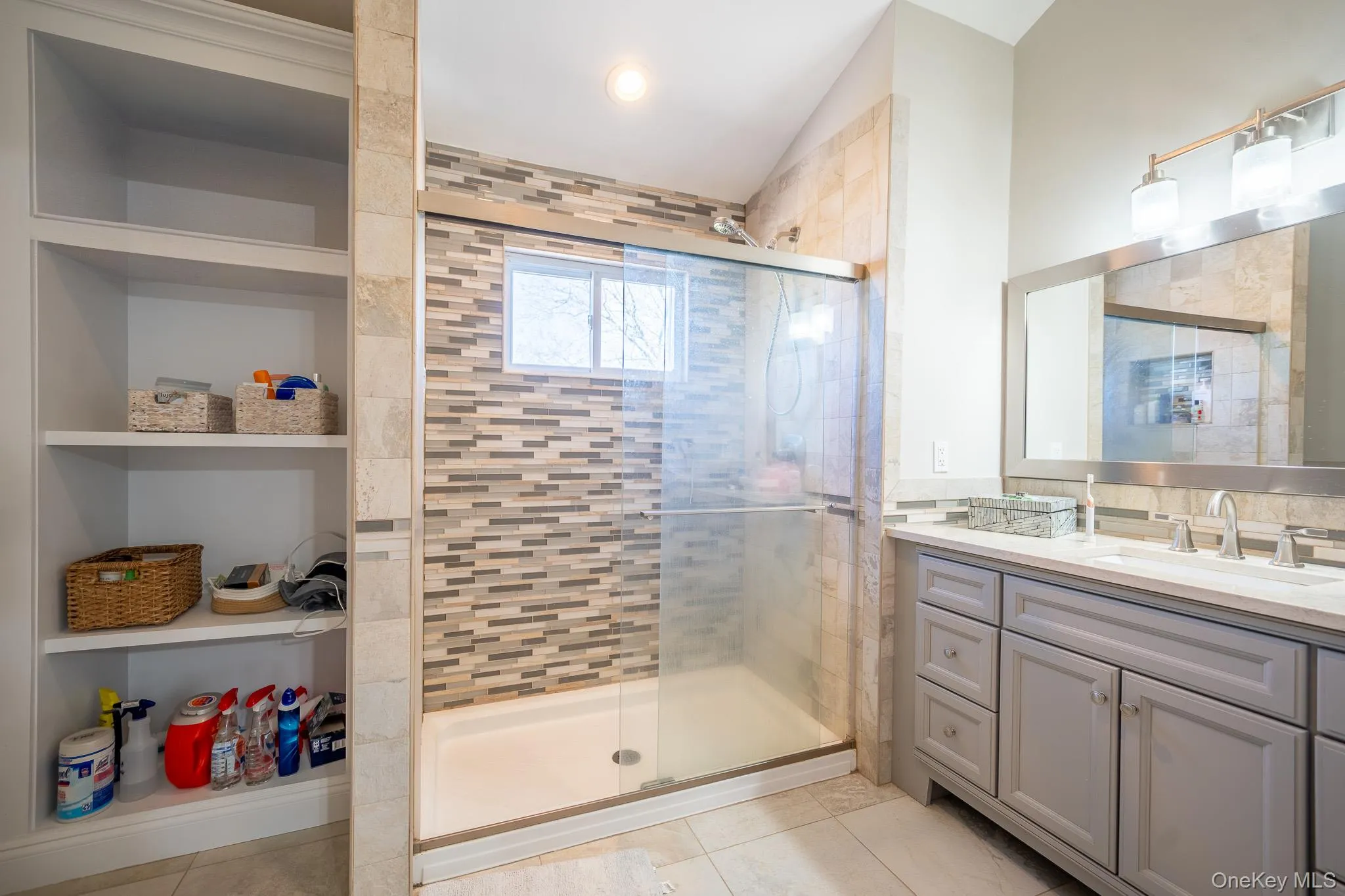 Bathroom with a shower stall, vaulted ceiling, and tile patterned flooring Bathroom with a shower stall, vaulted ceiling, and tile patterned flooring