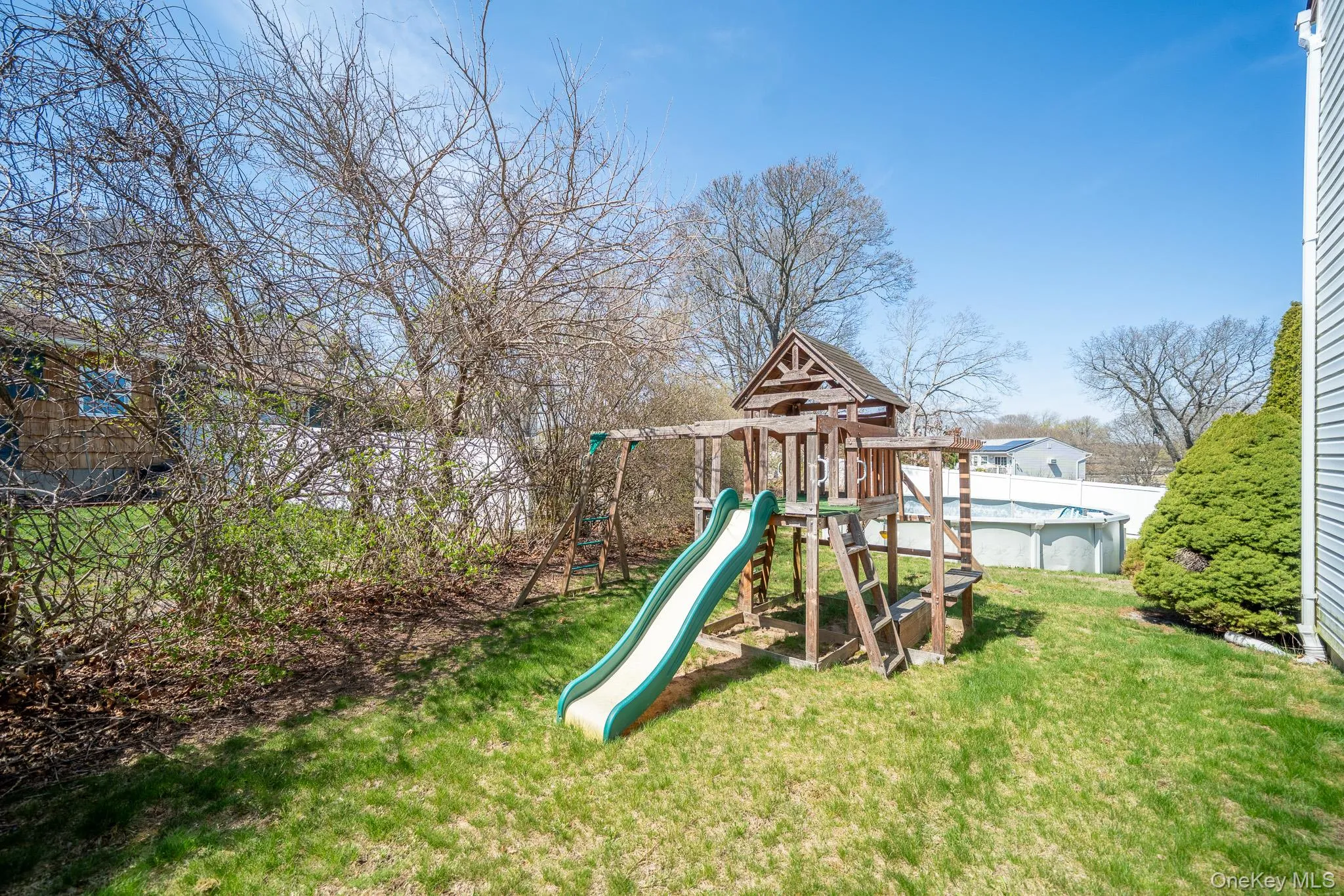 View of jungle gym with fence, a lawn, and a fenced in pool View of jungle gym with fence, a lawn, and a fenced in pool