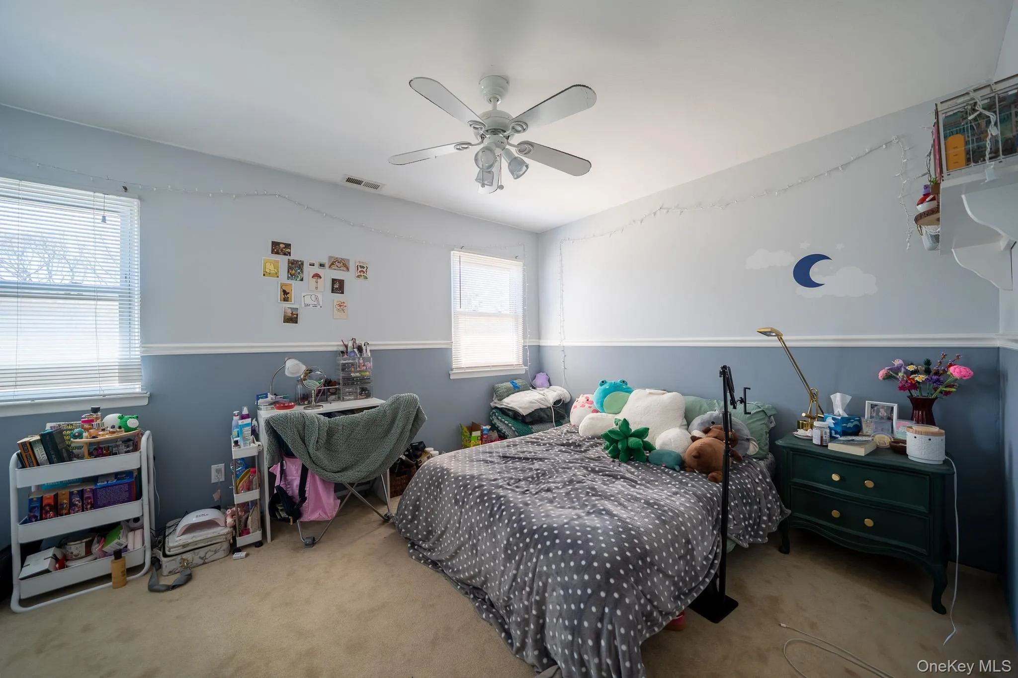 Bedroom with ceiling fan, carpet floors, and visible vents Bedroom with ceiling fan, carpet floors, and visible vents