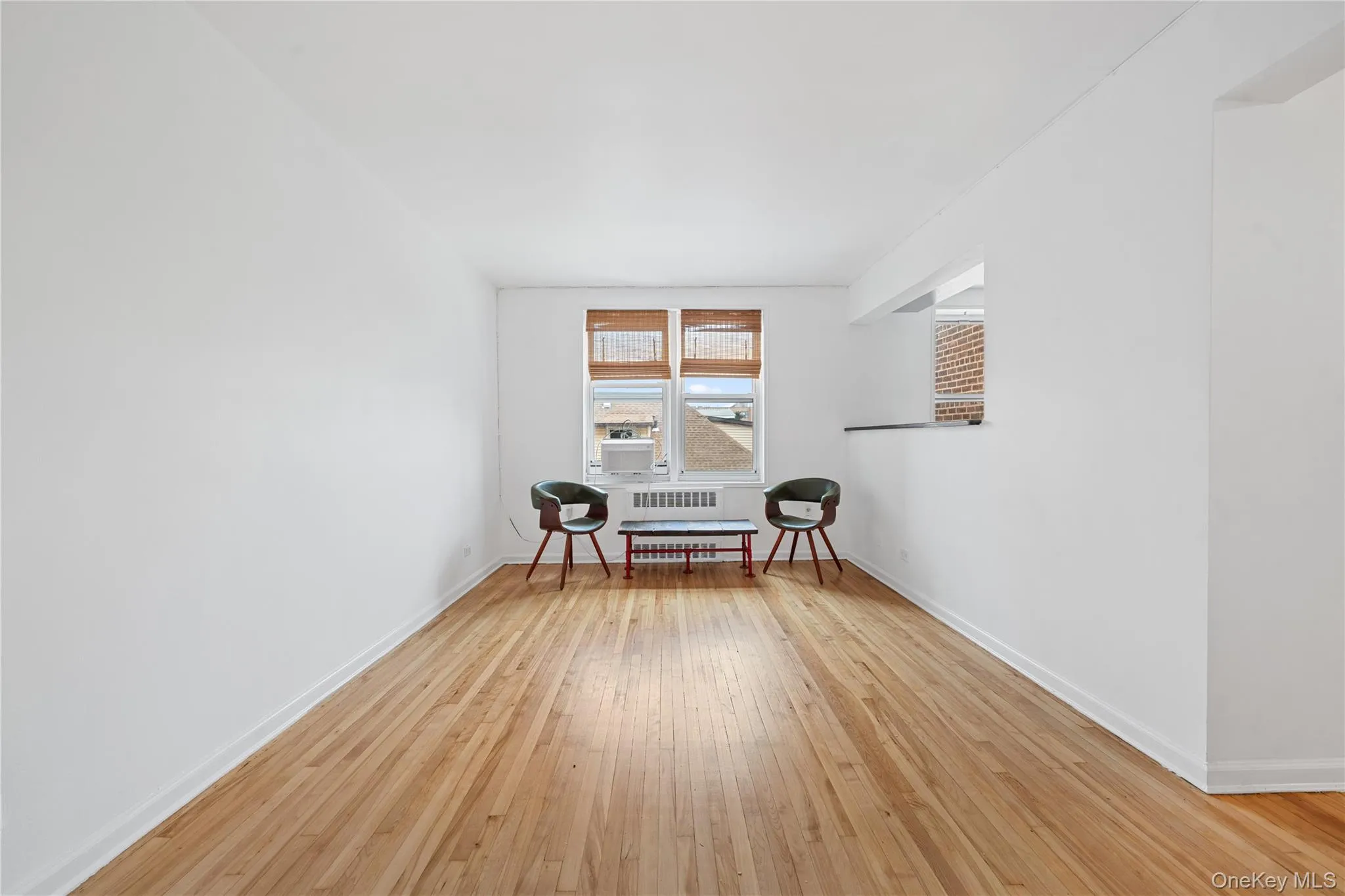 Hardwood flooring and a window with blinds Hardwood flooring and a window with blinds