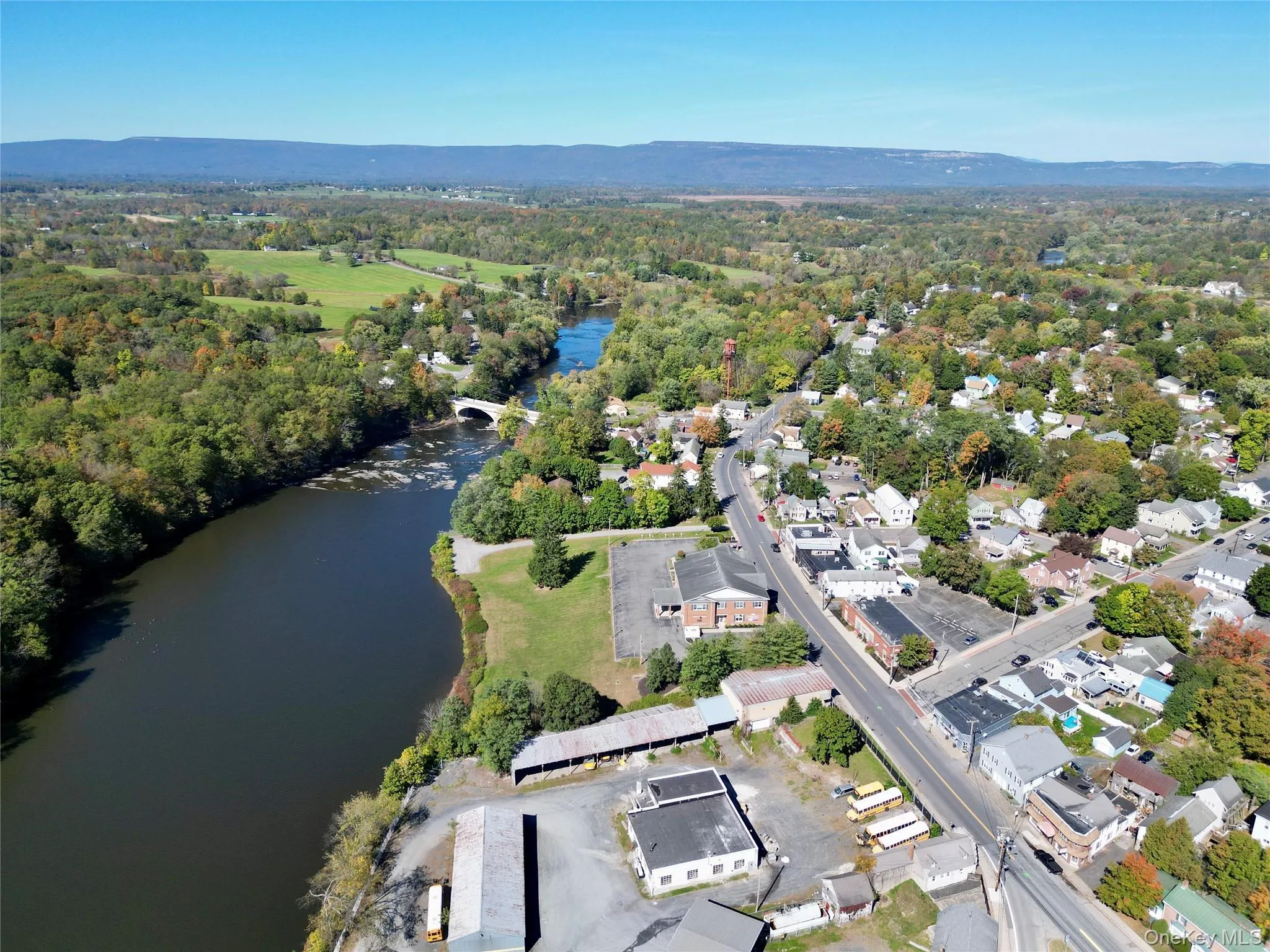 Aerial view featuring a forest view and a water view Aerial view featuring a forest view and a water view