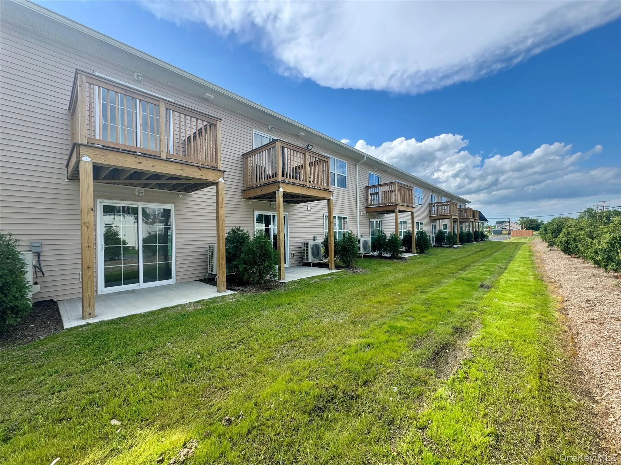 Back of property with a lawn and a patio area Back of property with a lawn and a patio area