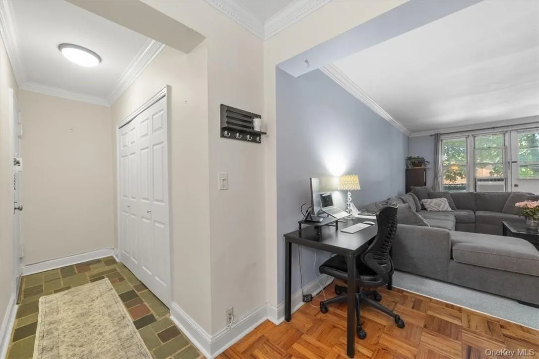 Home office featuring dark parquet flooring and ornamental molding Home office featuring dark parquet flooring and ornamental molding