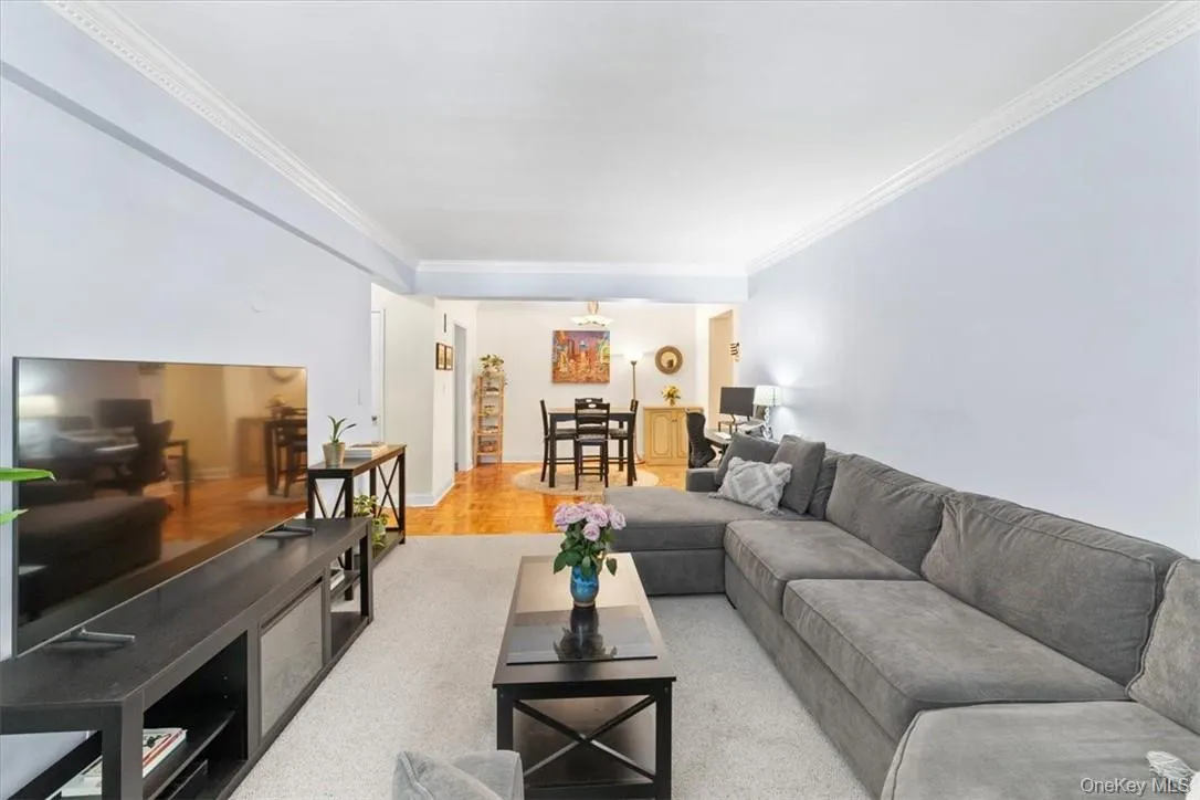 Living room with crown molding and hardwood / wood-style flooring Living room with crown molding and hardwood / wood-style flooring