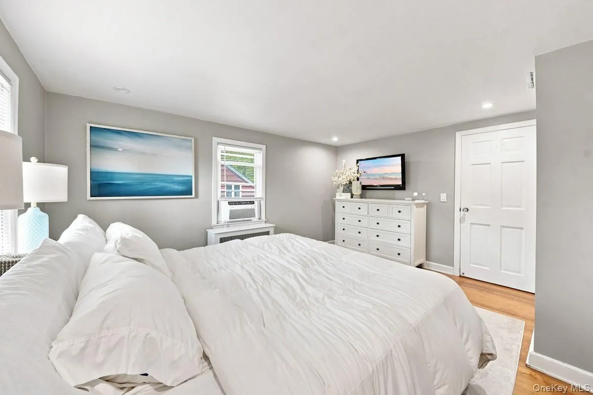 Another view of the primary bedroom with recessed lighting and hardwood flooring. Another view of the primary bedroom with recessed lighting and hardwood flooring.
