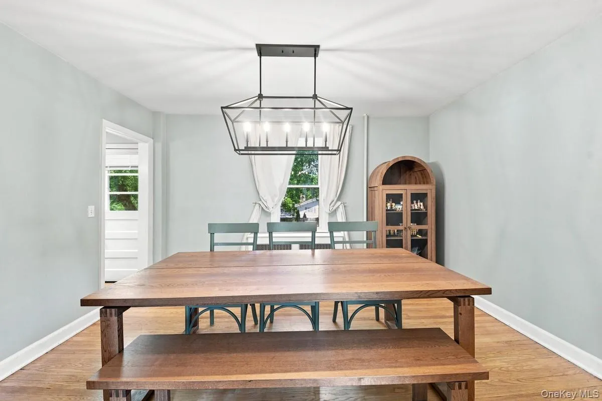Hardwood flooring, contemporary light fixture, and doorway to kitchen. Hardwood flooring, contemporary light fixture, and doorway to kitchen.