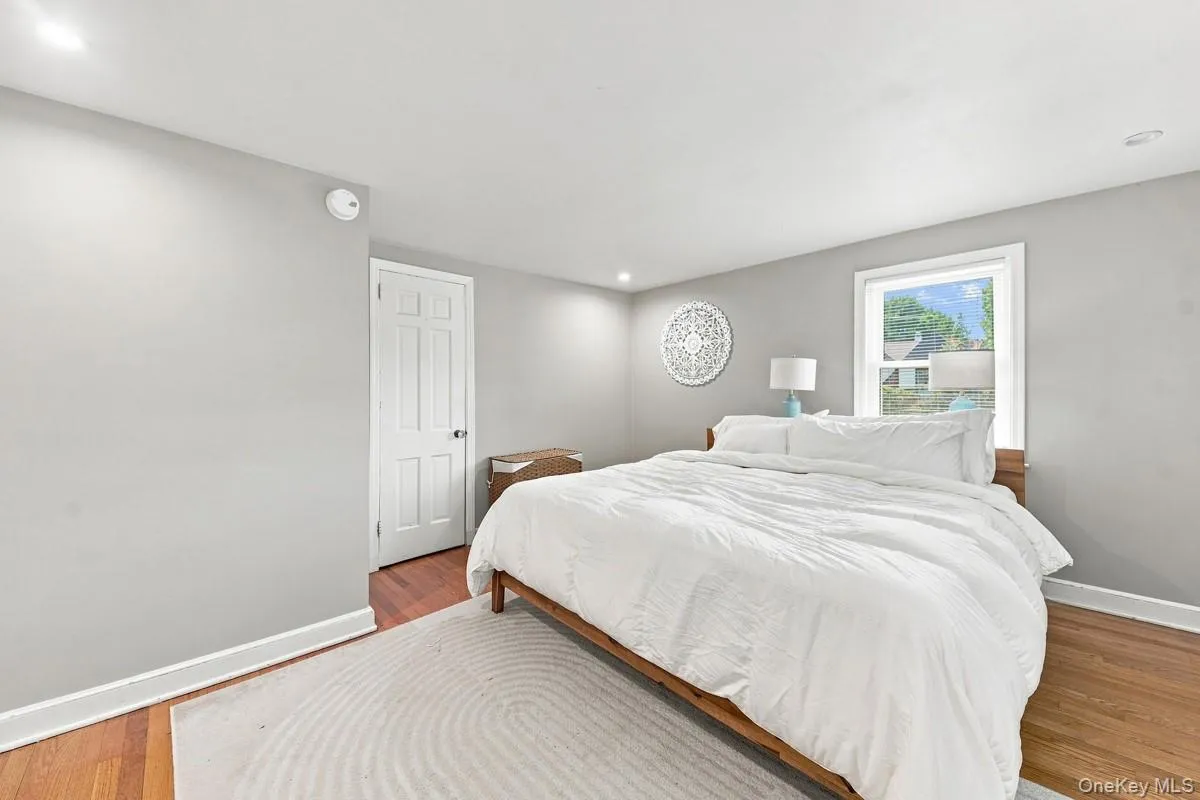 Primary bedroom with recessed lighting and hardwood flooring. Primary bedroom with recessed lighting and hardwood flooring.