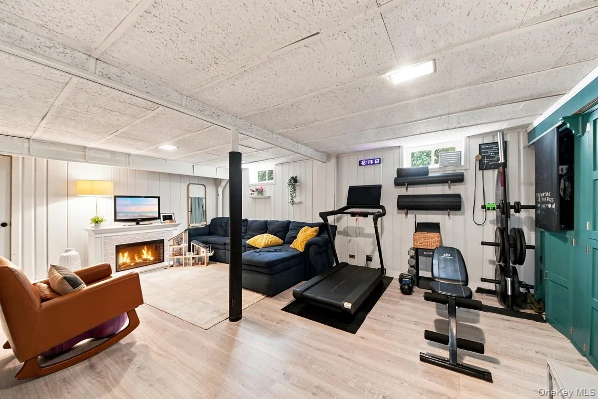 Finished basement with a spacious recreation room, wood-look laminate flooring, and plenty of room for multiple seating areas, a home gym, hobbies, or other flexible uses. Finished basement with a spacious recreation room, wood-look laminate flooring, and plenty of room for multiple seating areas, a home gym, hobbies, or other flexible uses.