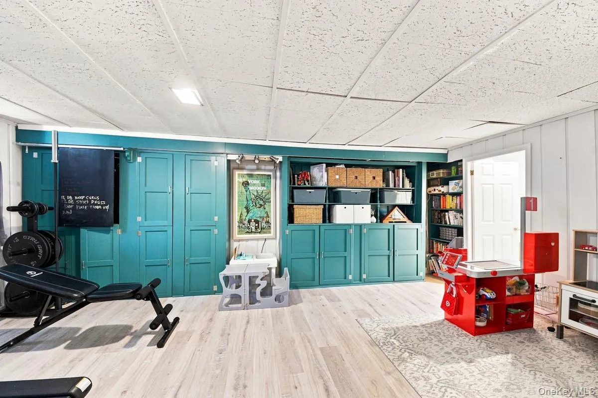 Freshly painted built-in shelves add character and convenient storage to the finished lower level. Freshly painted built-in shelves add character and convenient storage to the finished lower level.