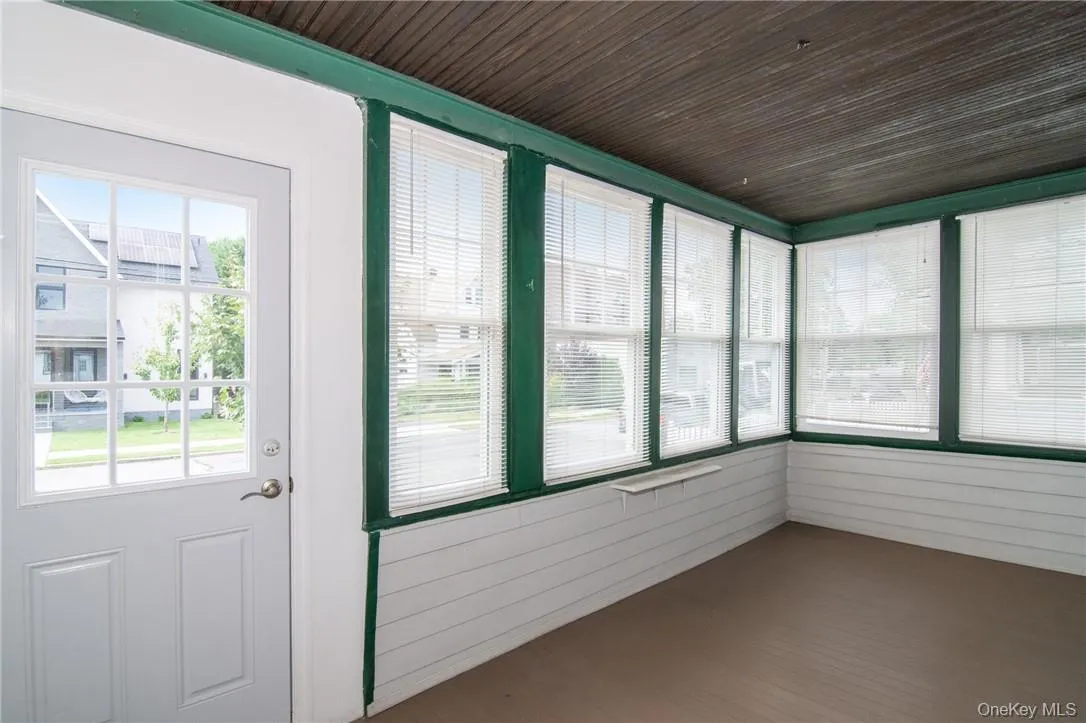 sunroom with a wealth of natural light and wooden ceiling sunroom with a wealth of natural light and wooden ceiling