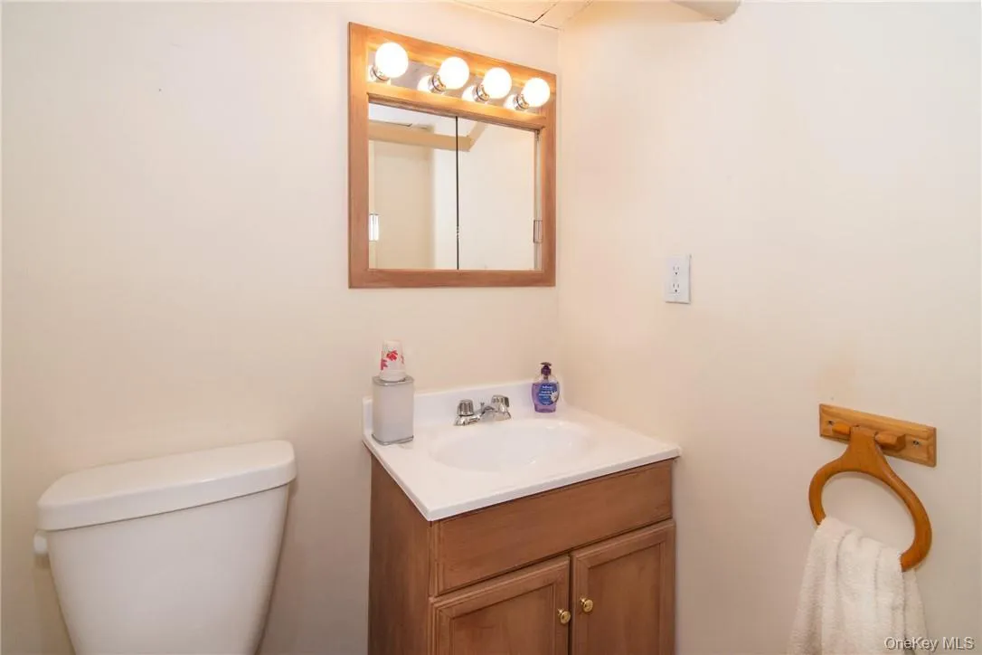 Bathroom with toilet and vanity Bathroom with toilet and vanity