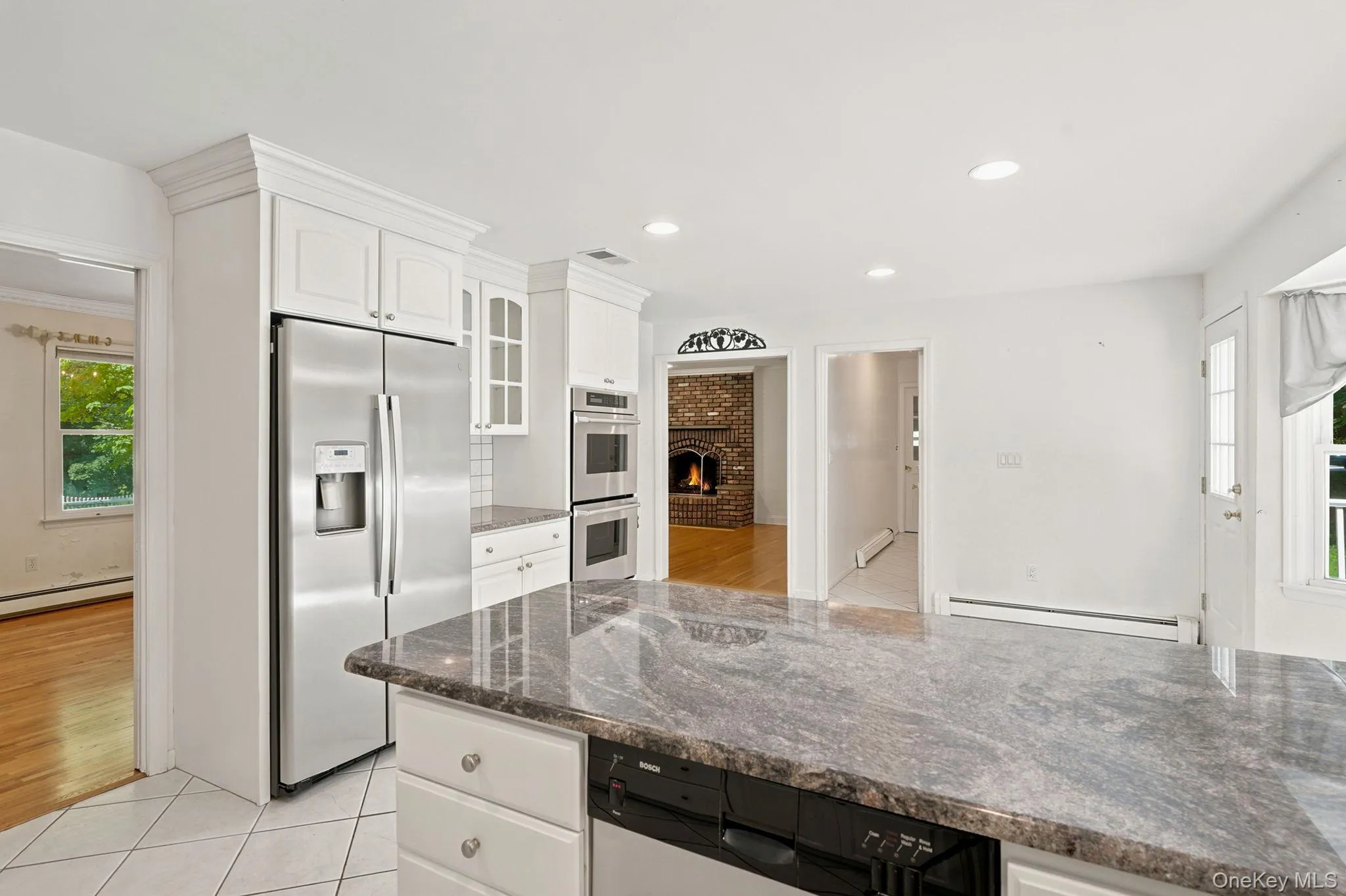 This view shows access to dining room and family room and the the hallway to right of family room entrance is location of powder room, laundry area and door to 2 car garage This view shows access to dining room and family room and the the hallway to right of family room entrance is location of powder room, laundry area and door to 2 car garage