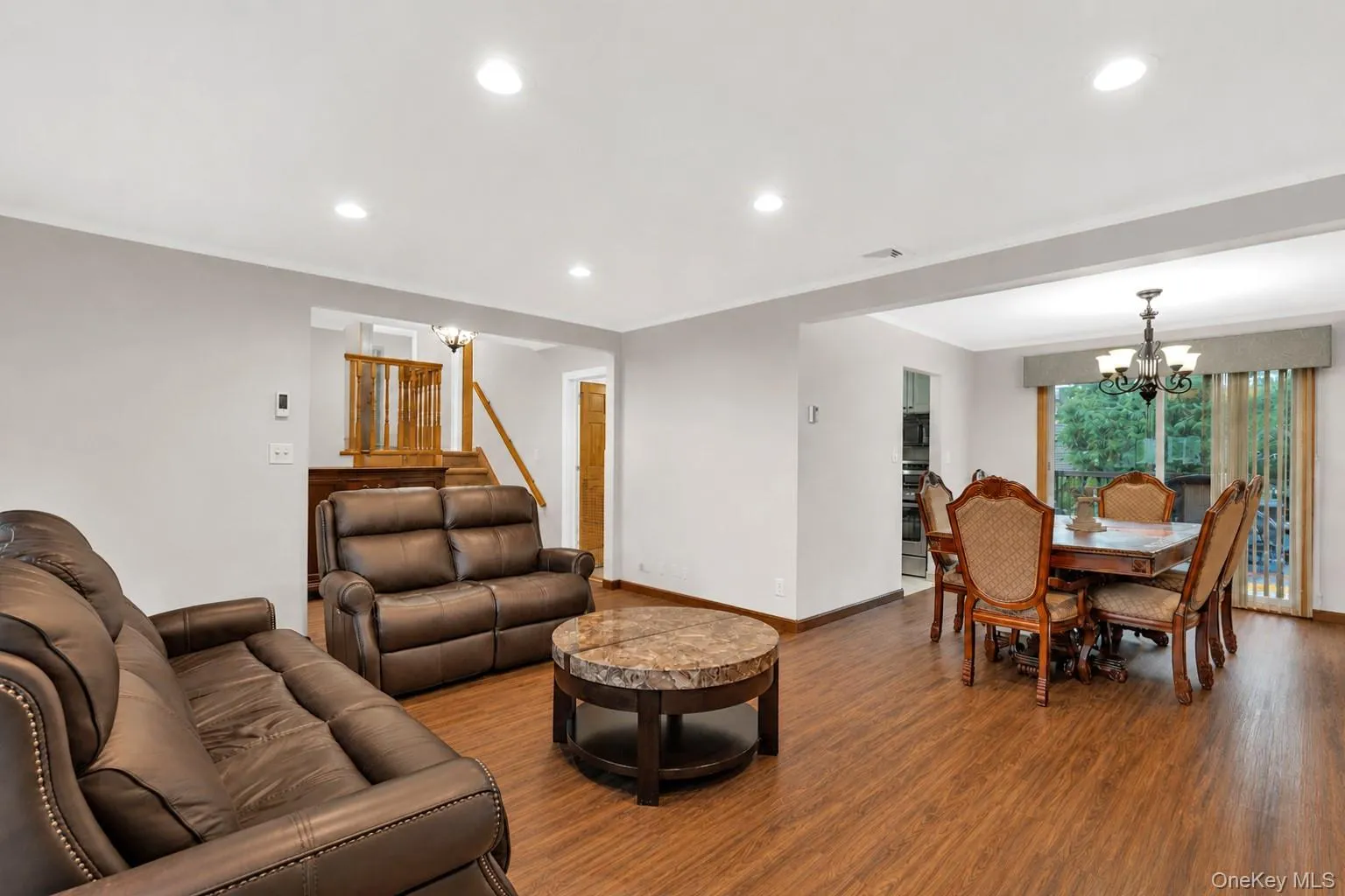 Flexible Living space with recessed lighting, and a defined dining space with leading to backyard access. Flexible Living space with recessed lighting, and a defined dining space with leading to backyard access.