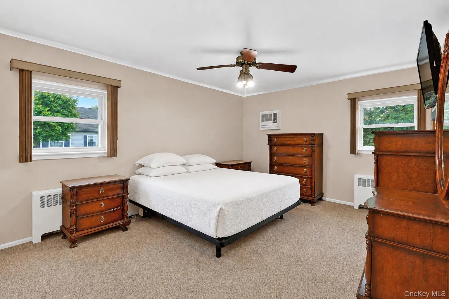 Carpeted bedroom with neutral wall tones and white crown molding Carpeted bedroom with neutral wall tones and white crown molding