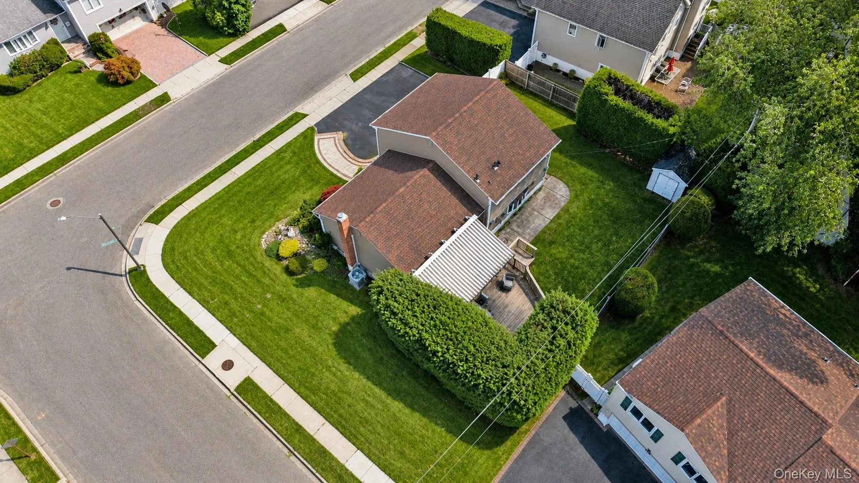 Corner lot residence featuring a two-story design with a spacious backyard, mature trees, and a detached shed Corner lot residence featuring a two-story design with a spacious backyard, mature trees, and a detached shed