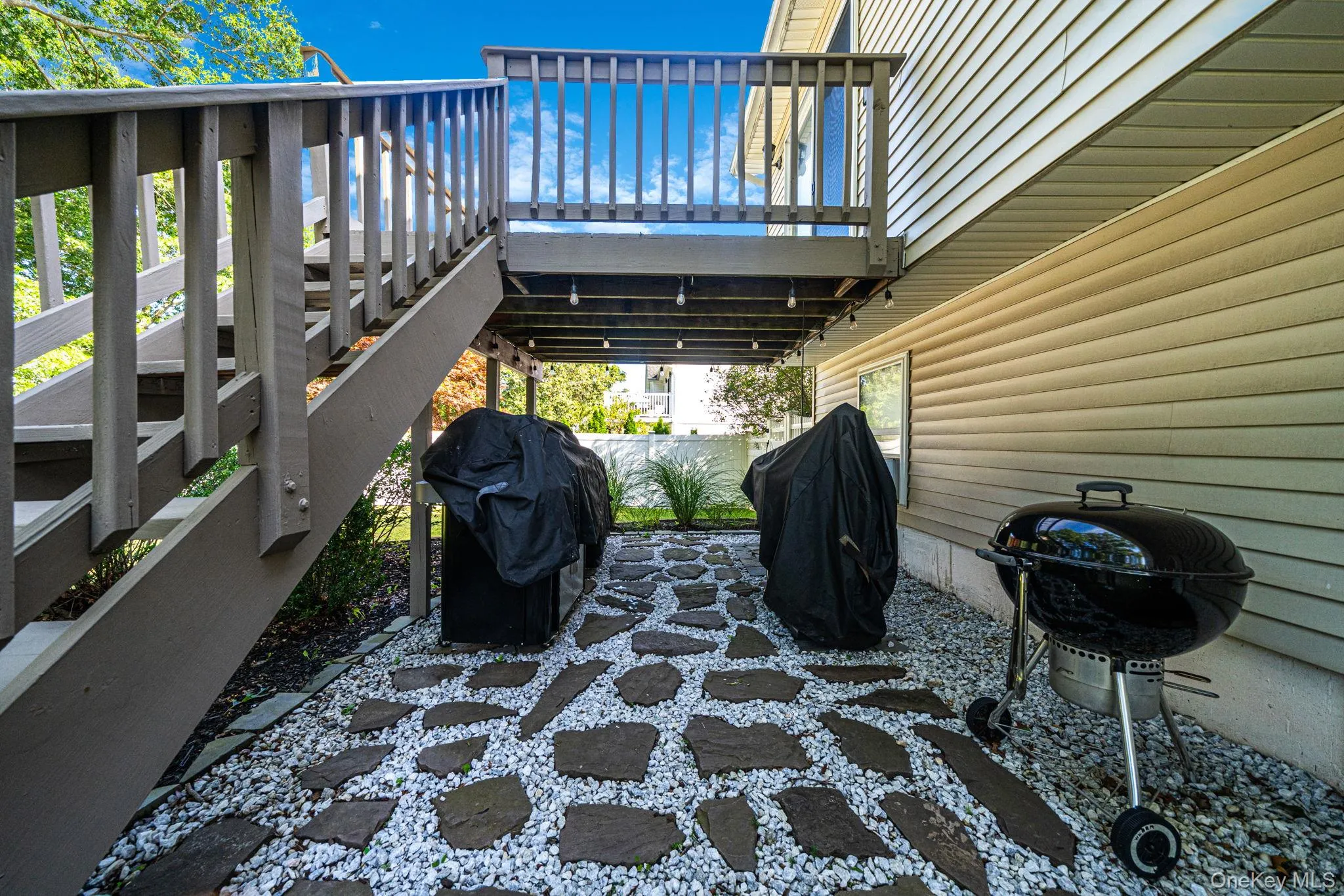 Covered outdoor entertaining space featuring a geometric patterned hardscape Covered outdoor entertaining space featuring a geometric patterned hardscape