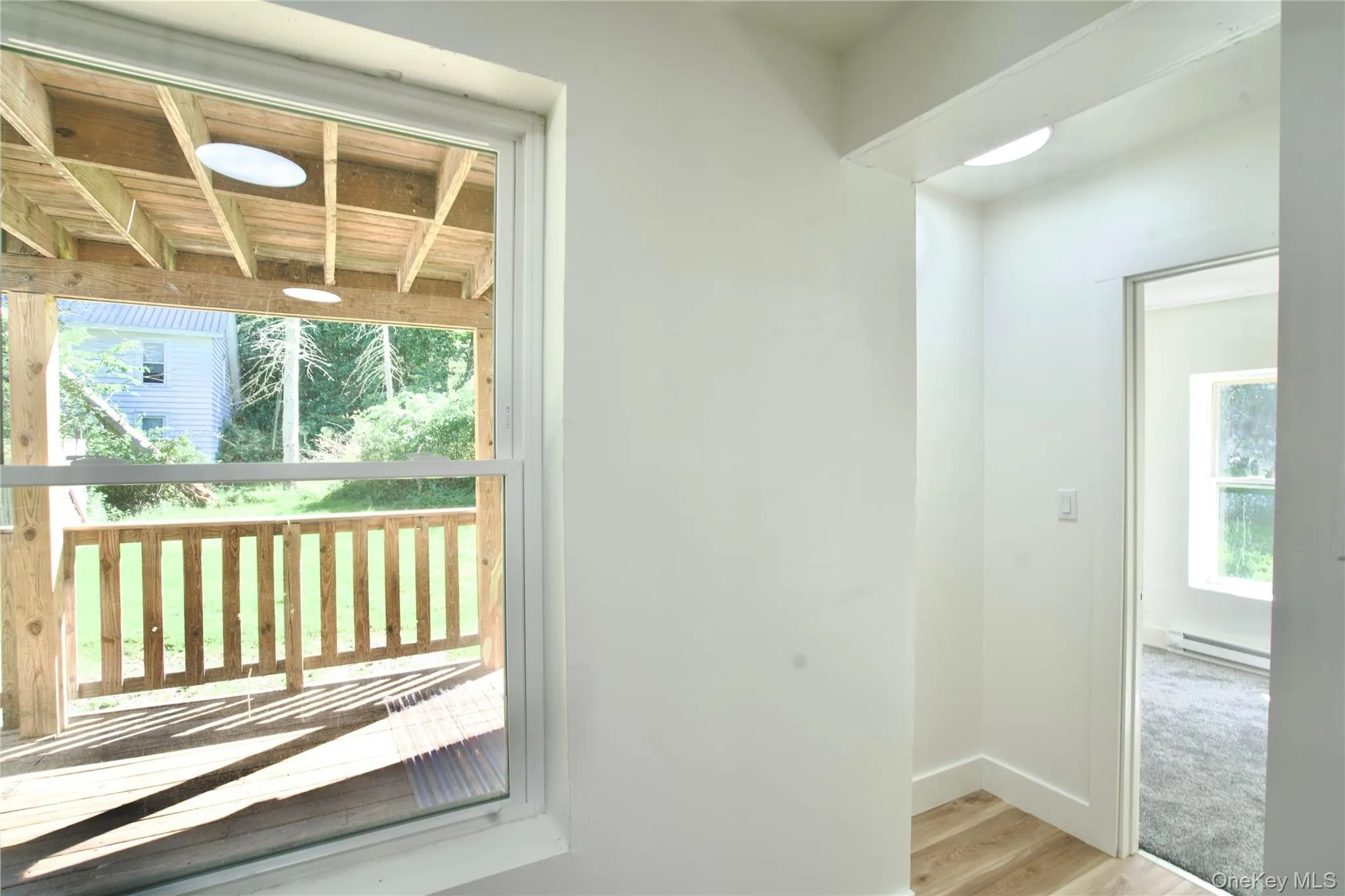Entryway featuring wood finished floors and a baseboard radiator Entryway featuring wood finished floors and a baseboard radiator