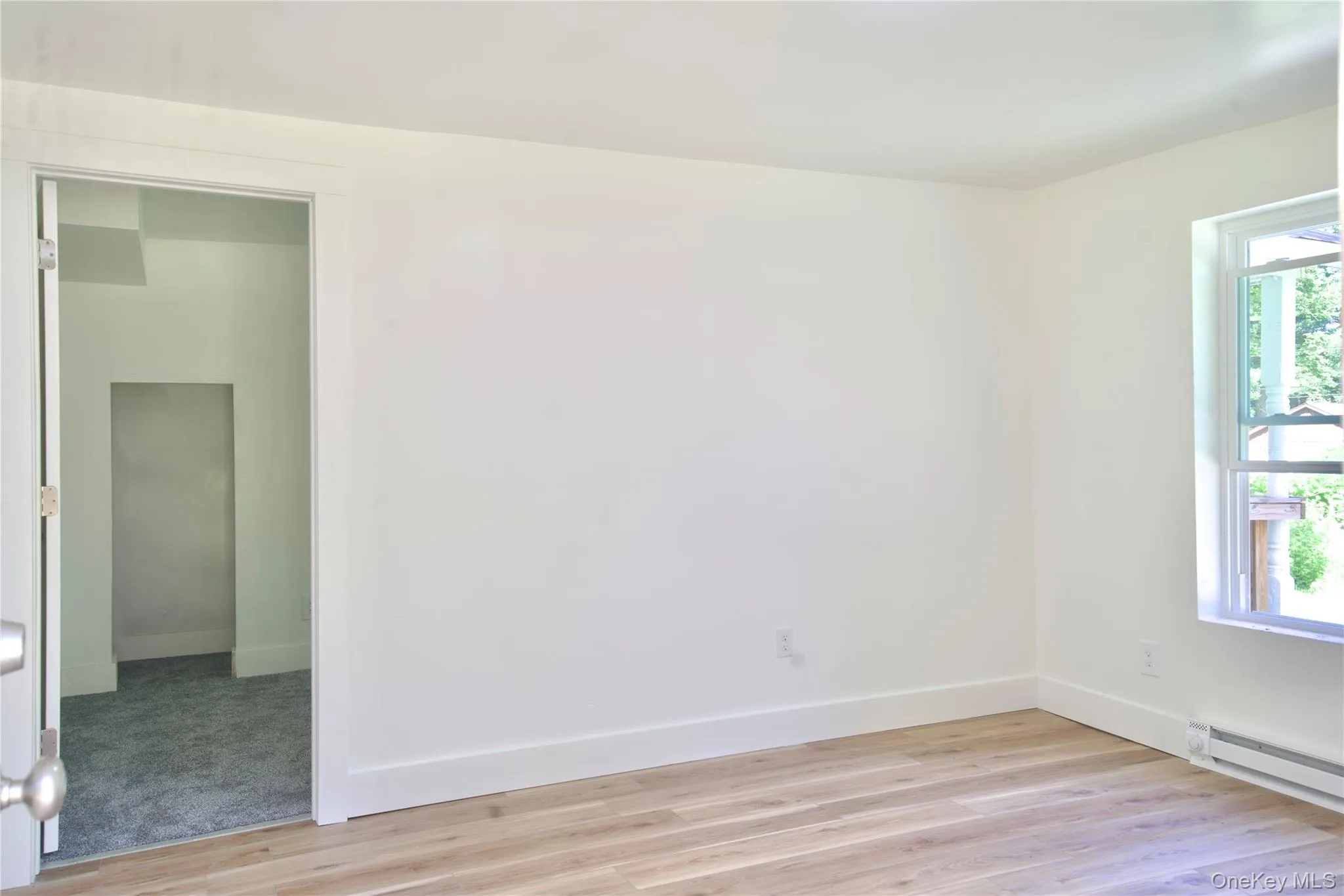 Empty room featuring light wood finished floors and baseboards Empty room featuring light wood finished floors and baseboards