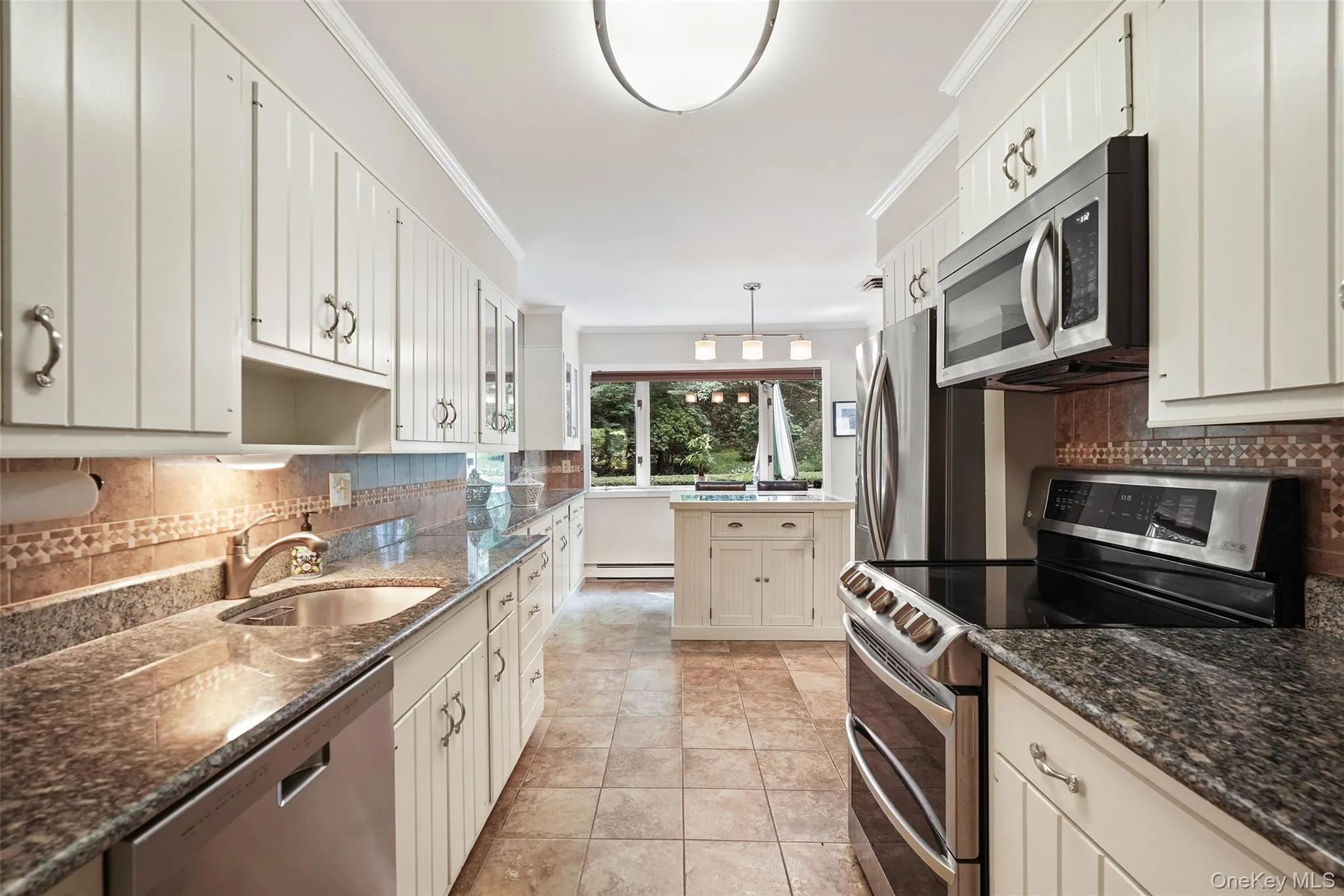 Updated kitchen with granite counters, stainless steel appliances and island with storage Updated kitchen with granite counters, stainless steel appliances and island with storage