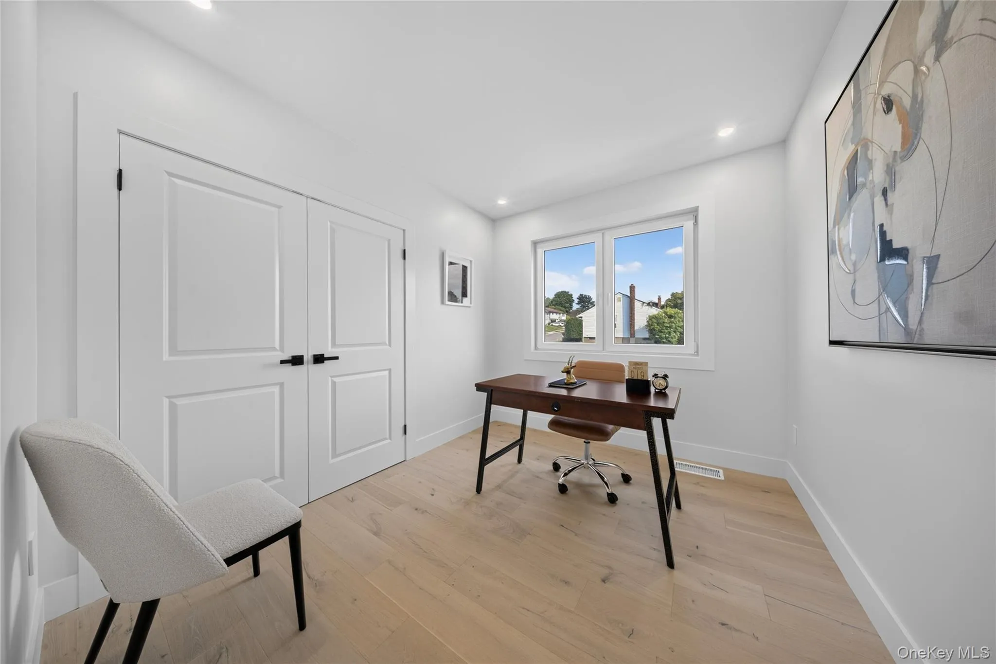 Recessed lighting, wood-finish flooring, and white walls with thick baseboards Recessed lighting, wood-finish flooring, and white walls with thick baseboards