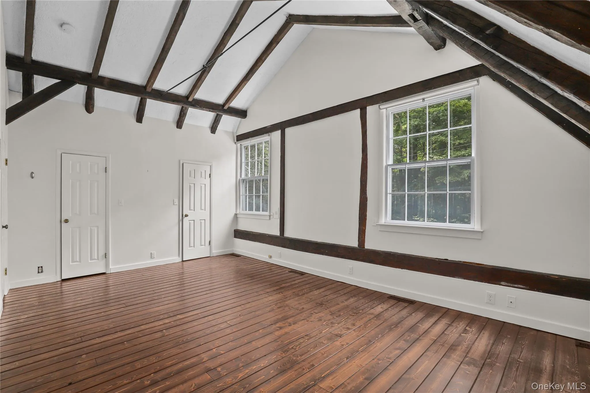 Primary bedroom with open, beamed ceiling. Primary bedroom with open, beamed ceiling.
