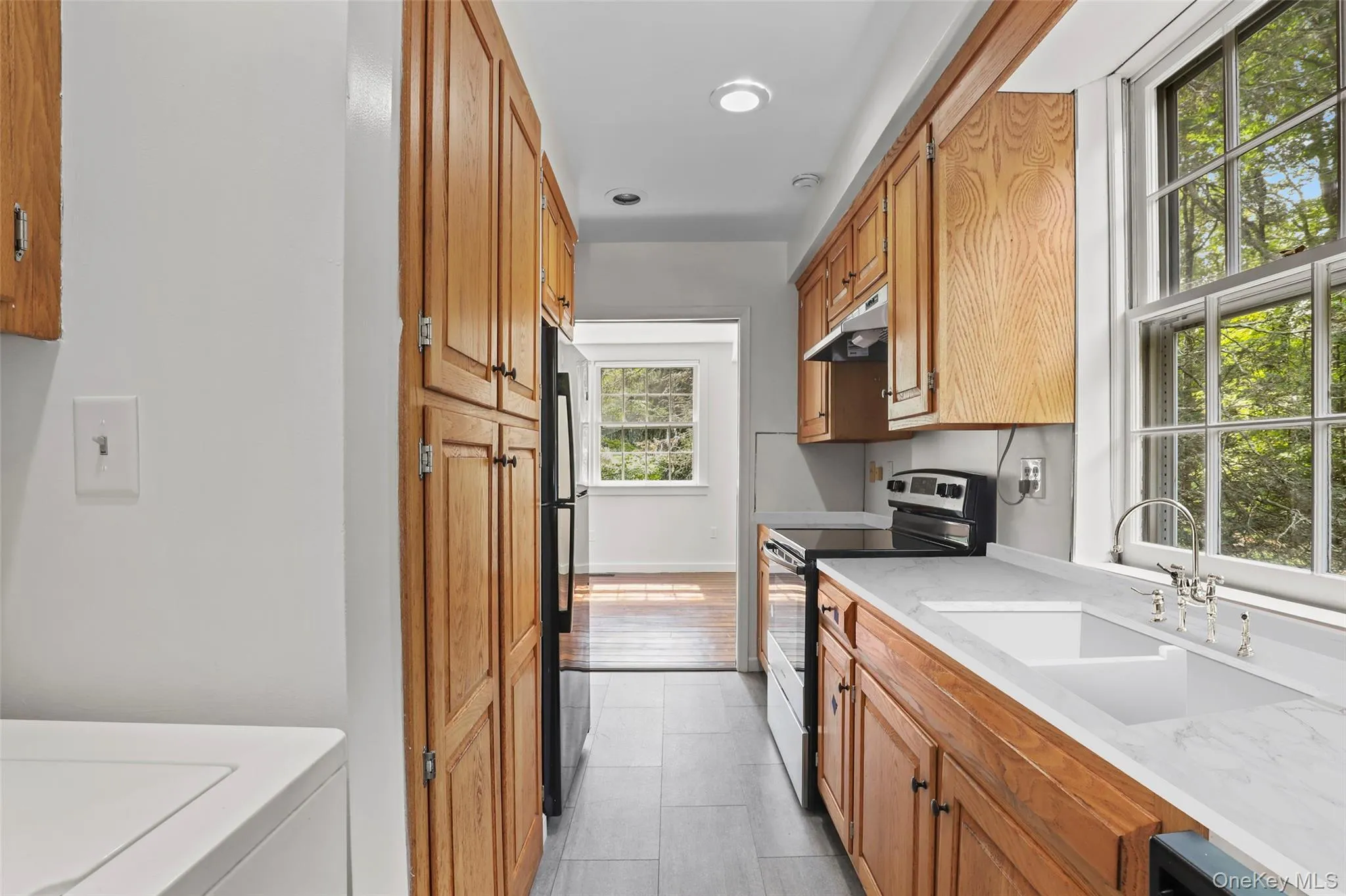 Another view of the kitchen; washer and dryer on the left. Another view of the kitchen; washer and dryer on the left.