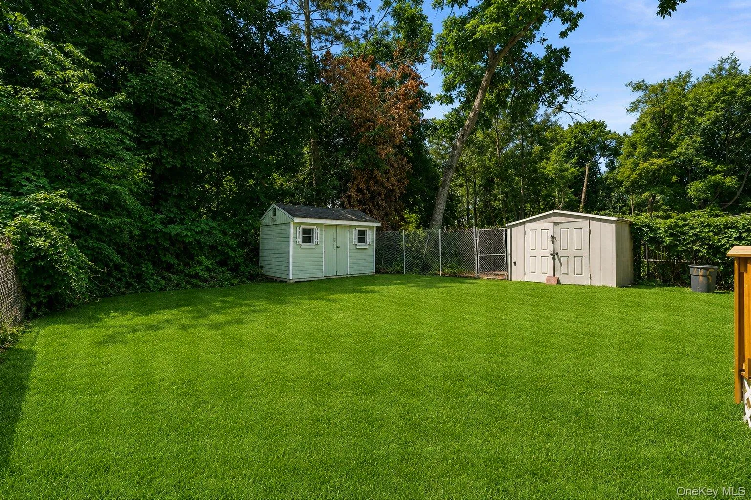 Expansive, level backyardsurrounded by mature trees,featuring two storage shedsand plenty of room for outdooractivities. Expansive, level backyardsurrounded by mature trees,featuring two storage shedsand plenty of room for outdooractivities.