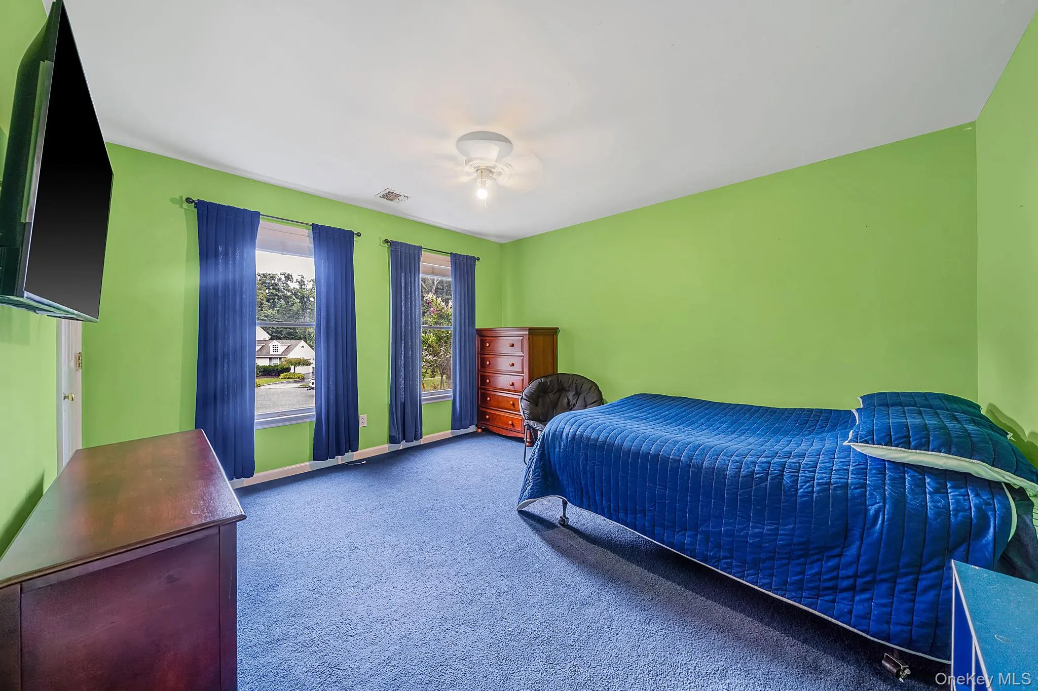 Room featuring large windows blue carpet flooring Room featuring large windows blue carpet flooring