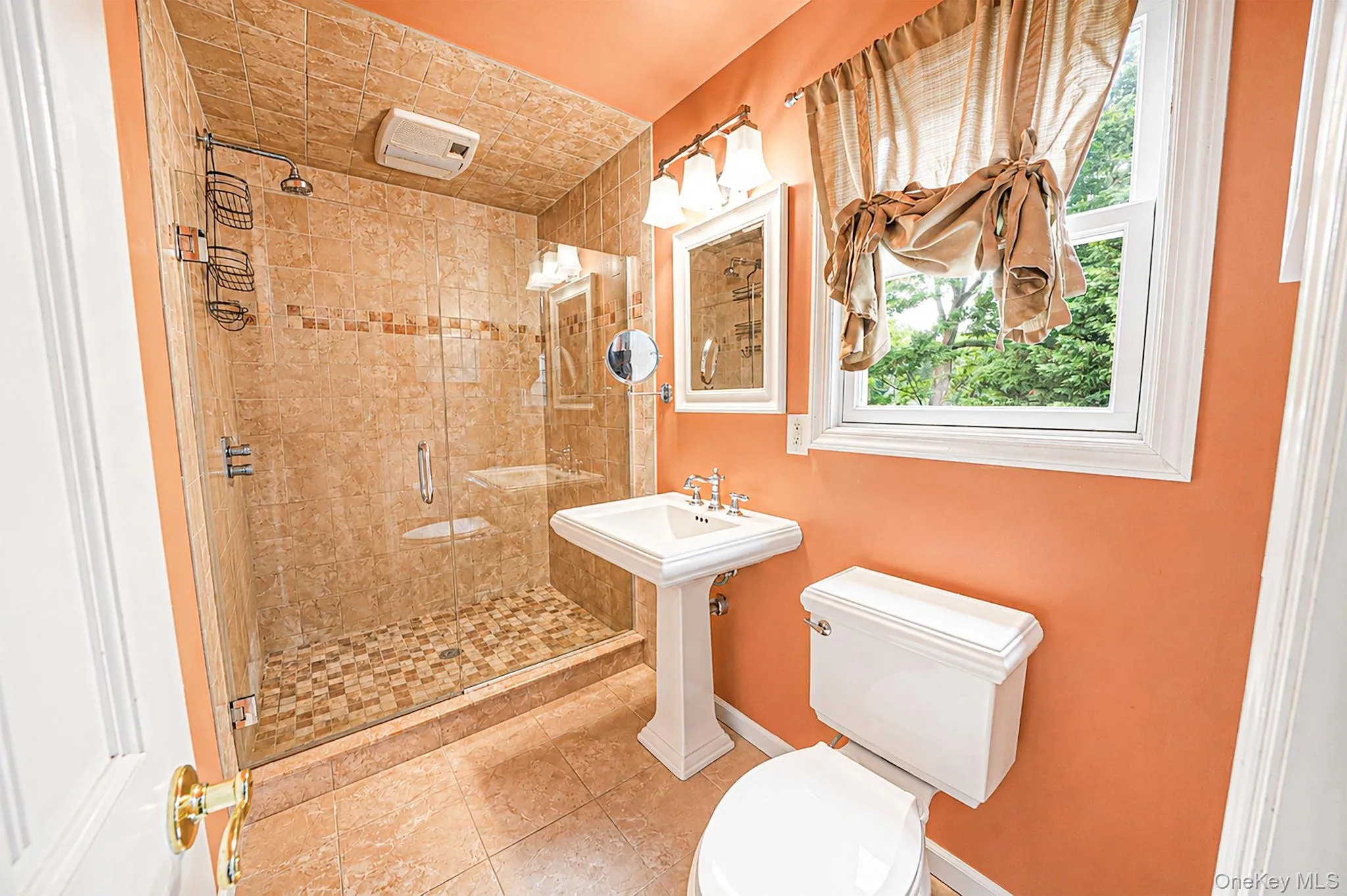 Walk-in shower with full tile surround and glass enclosure Walk-in shower with full tile surround and glass enclosure