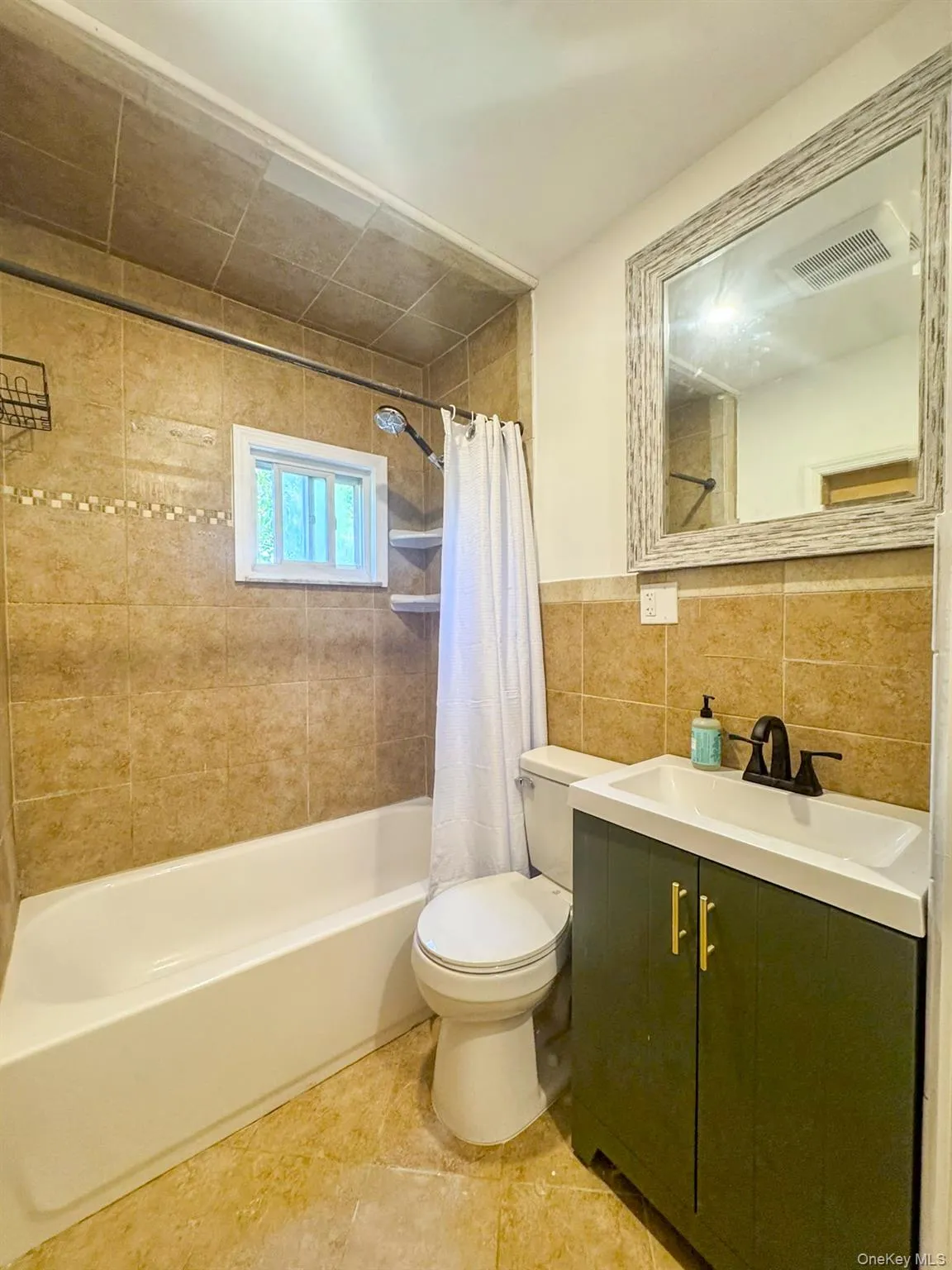 Newer refinished tiled bathroom. Newer refinished tiled bathroom.