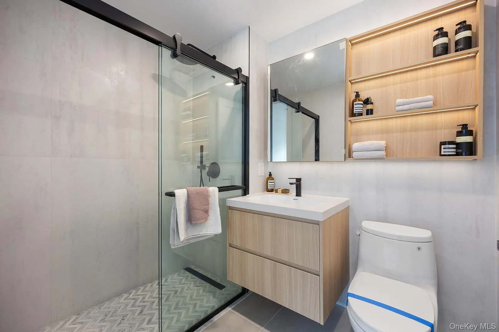 Full bath featuring vanity, a shower stall, and tile patterned flooring Full bath featuring vanity, a shower stall, and tile patterned flooring