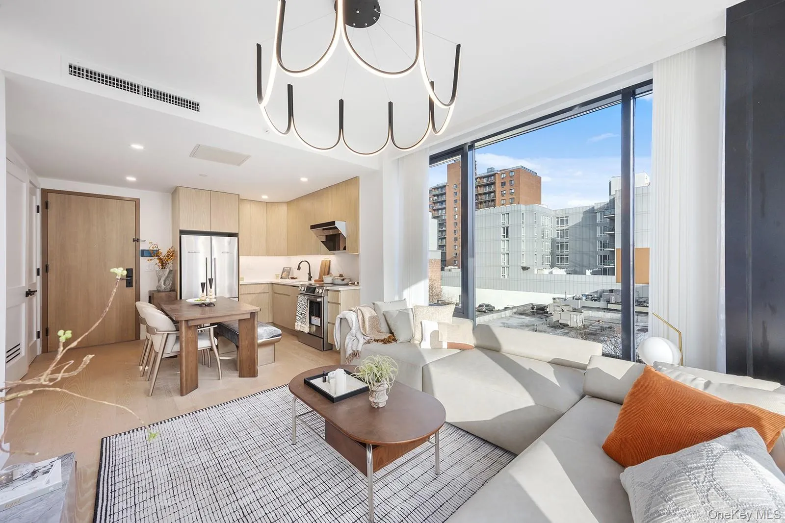 Living area with a chandelier, floor to ceiling windows, a view of city, and recessed lighting Living area with a chandelier, floor to ceiling windows, a view of city, and recessed lighting