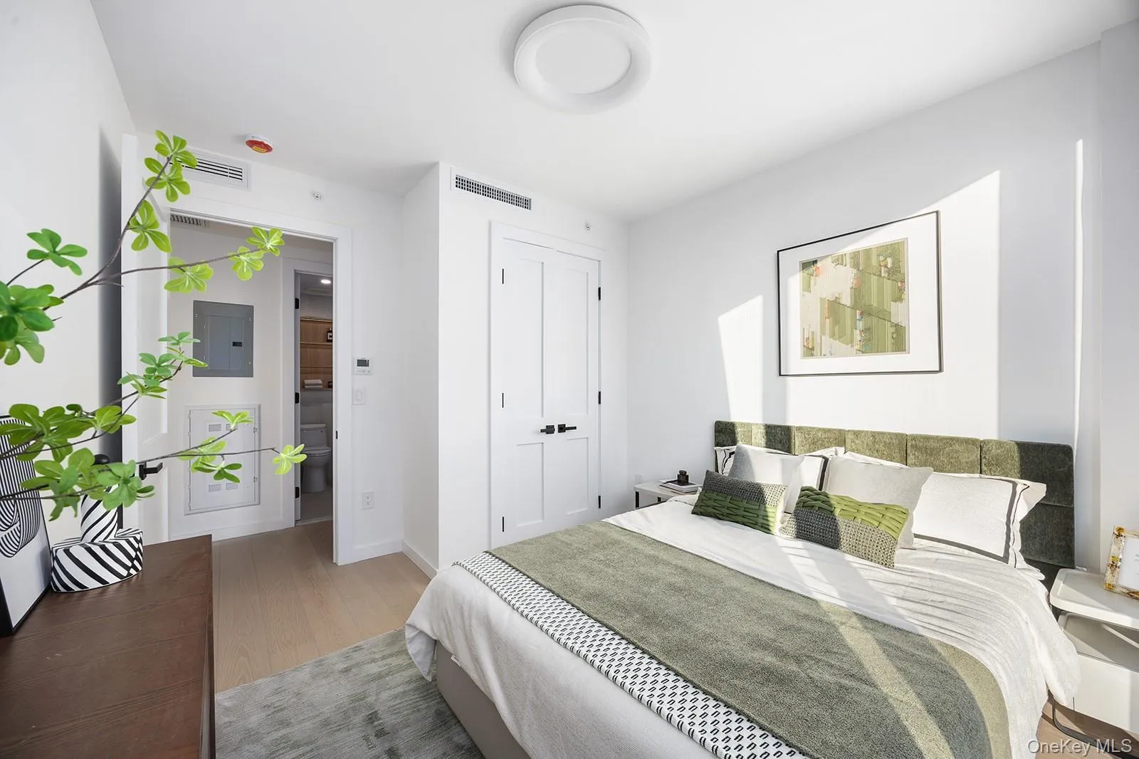 Bedroom with electric panel and light wood-type flooring Bedroom with electric panel and light wood-type flooring