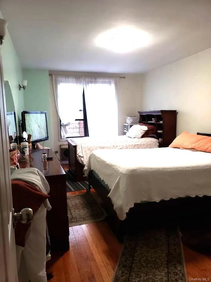 Bedroom featuring dark wood-style flooring Bedroom featuring dark wood-style flooring