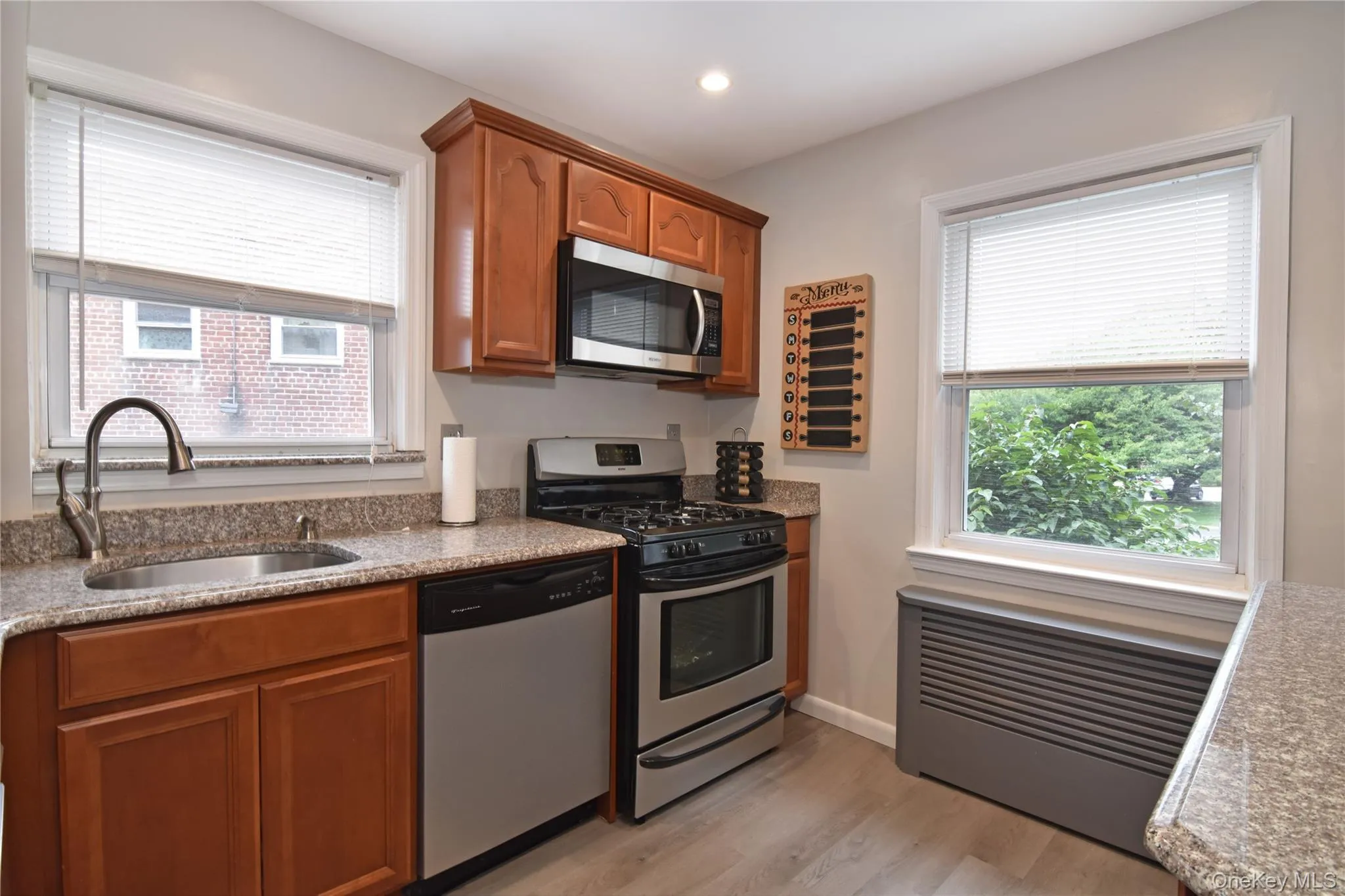 Double window exposure kitchen with stainless appliances, LVP flooring and granite countertops Double window exposure kitchen with stainless appliances, LVP flooring and granite countertops