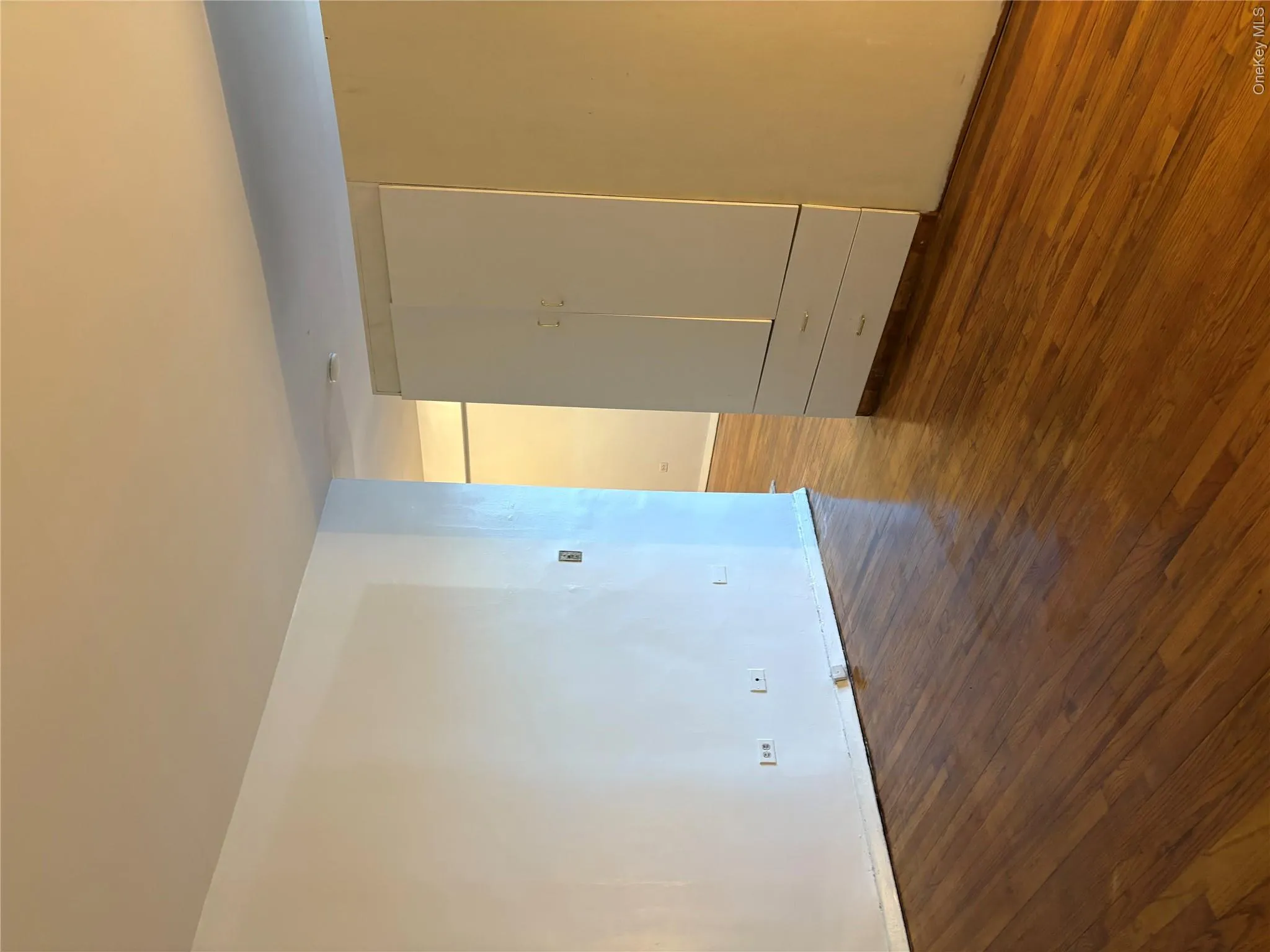 Empty room with baseboards and dark wood finished floors Empty room with baseboards and dark wood finished floors