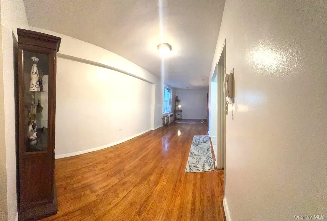 Hallway with wood finished floors and baseboards Hallway with wood finished floors and baseboards