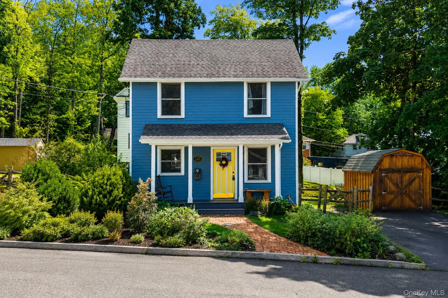 Blue siding exterior with a contrasting yellow entry door Blue siding exterior with a contrasting yellow entry door
