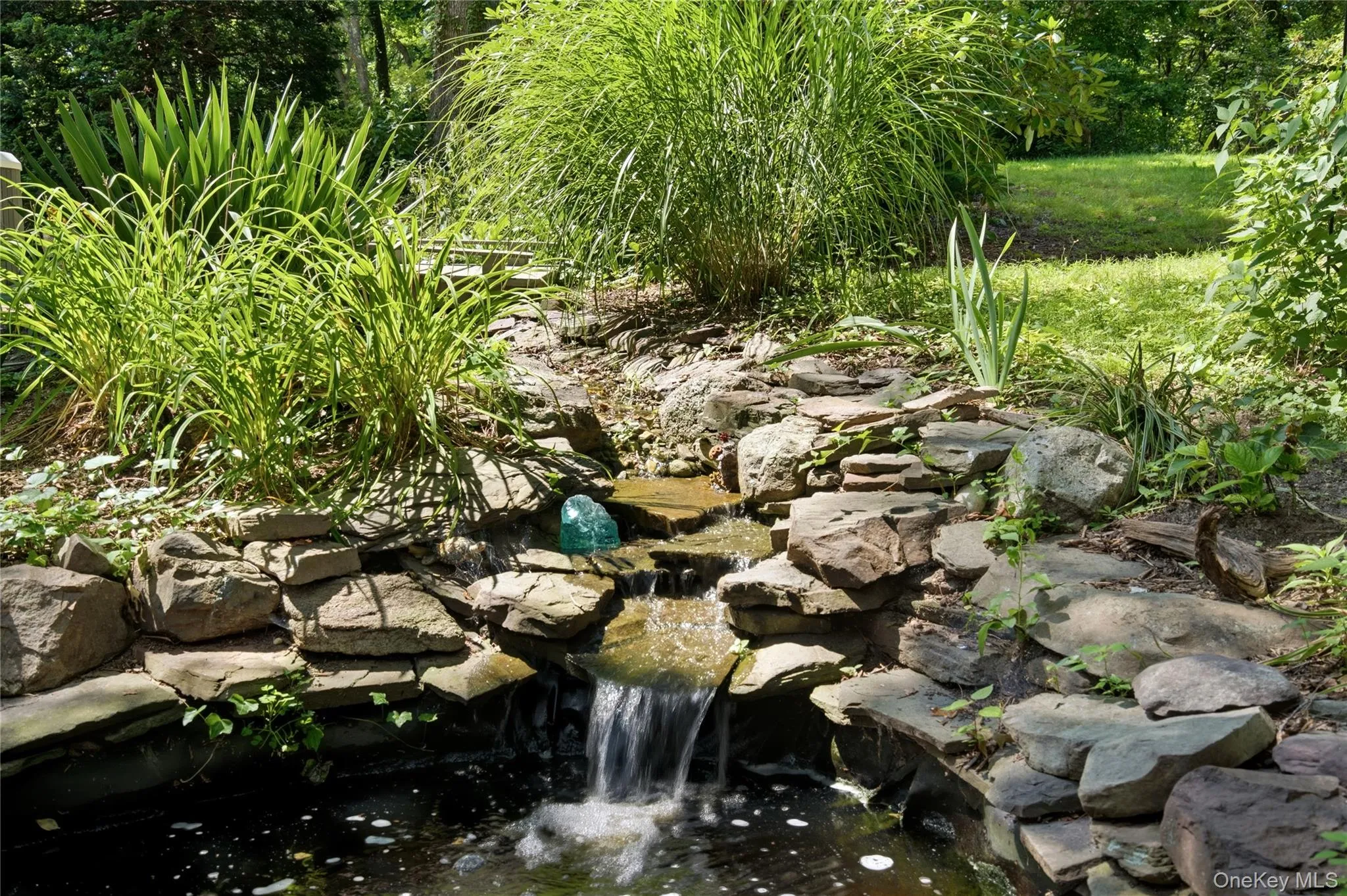 Running Water Features On The Property Lead From An Upper Pond To A Lower Pond Running Water Features On The Property Lead From An Upper Pond To A Lower Pond
